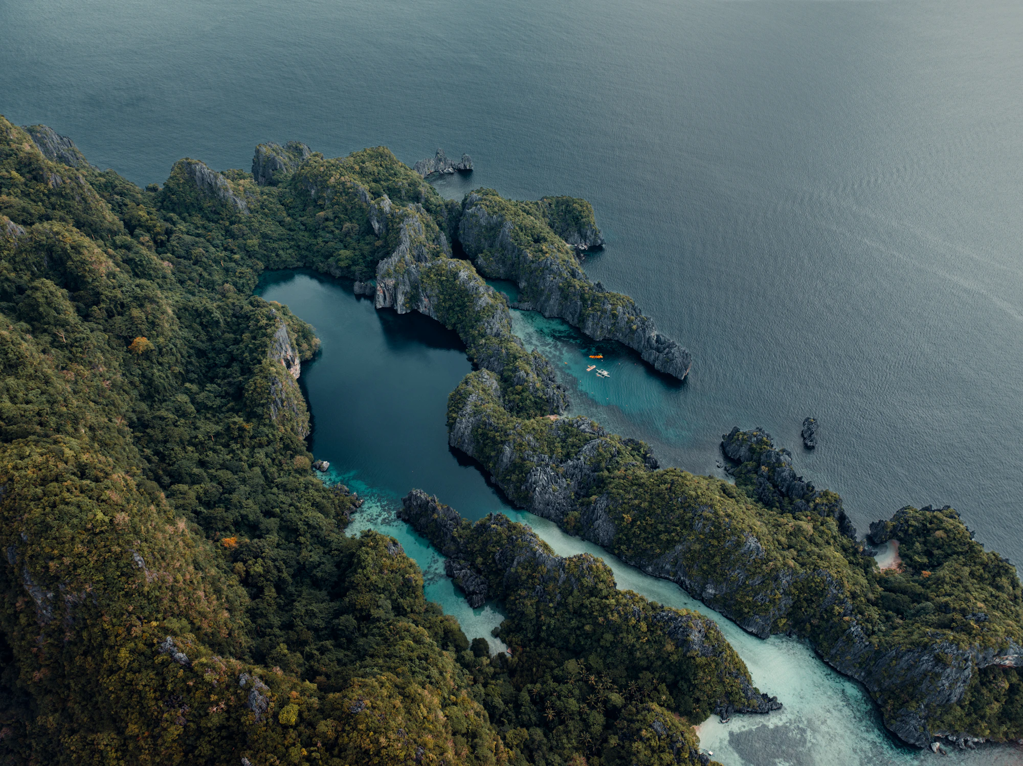 Jagged islands covered in lush green vegetation in the ocean
