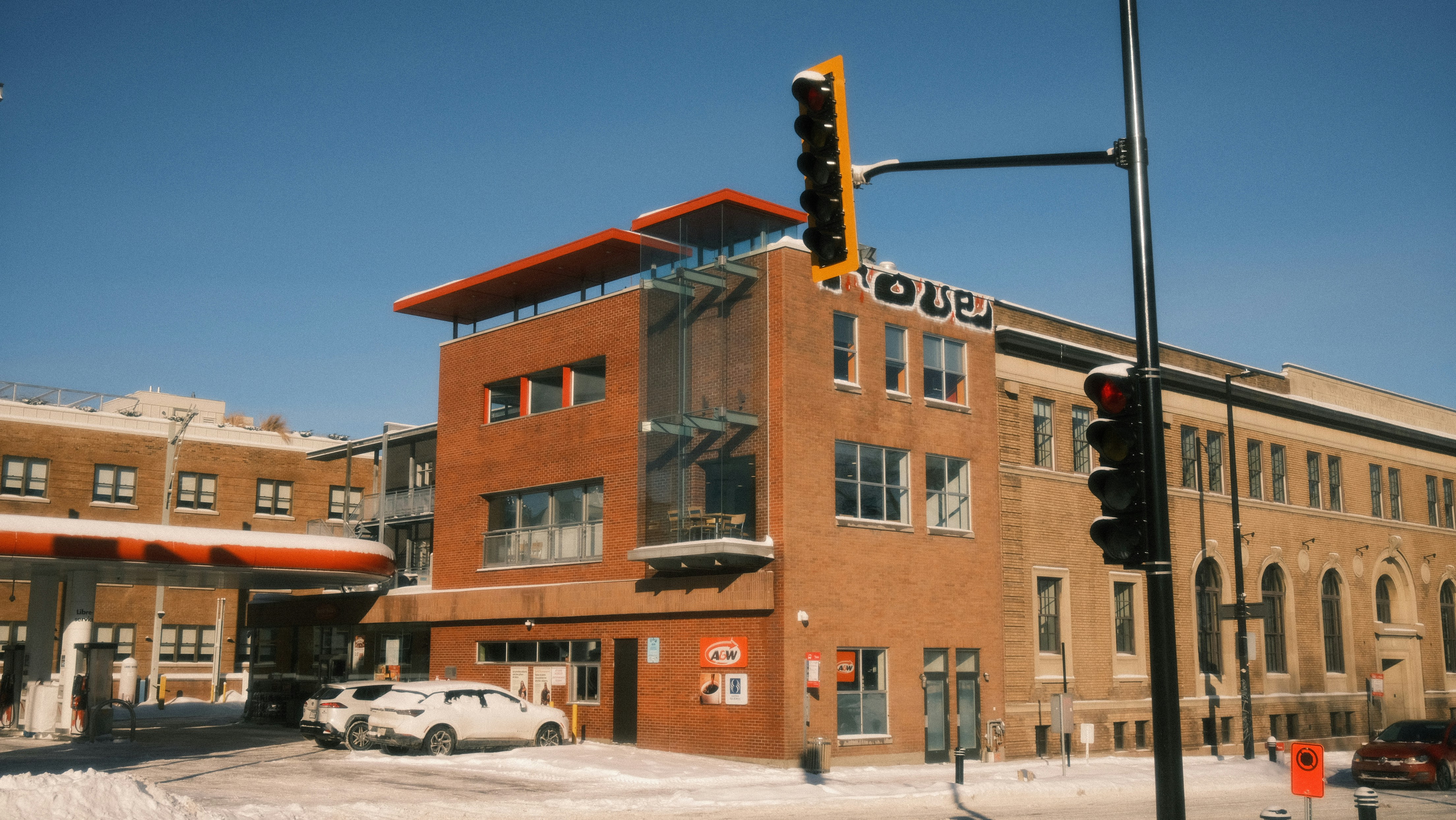 Brick building with snow and clear blue sky