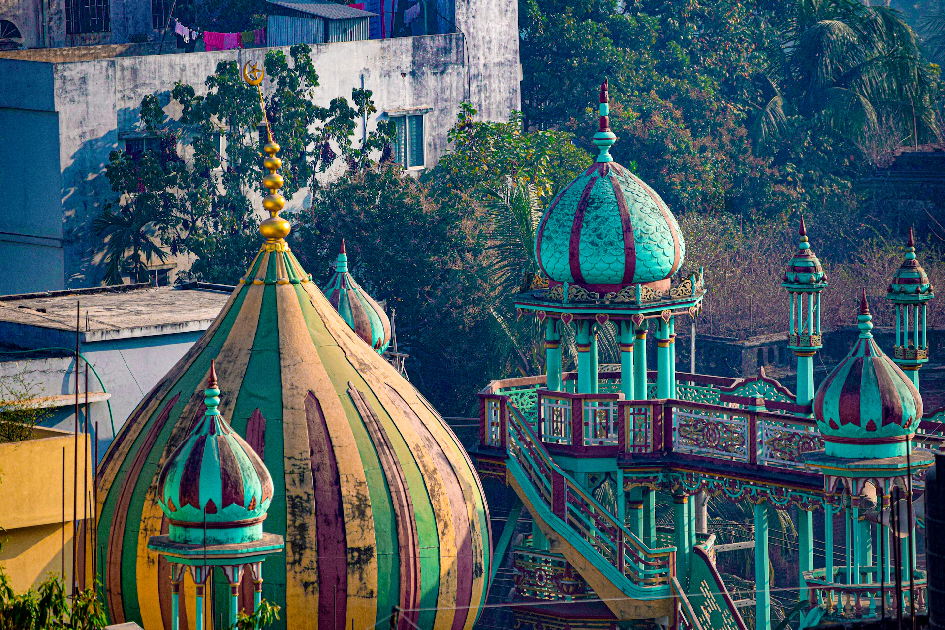 Colorful mosque domes and minarets against urban buildings