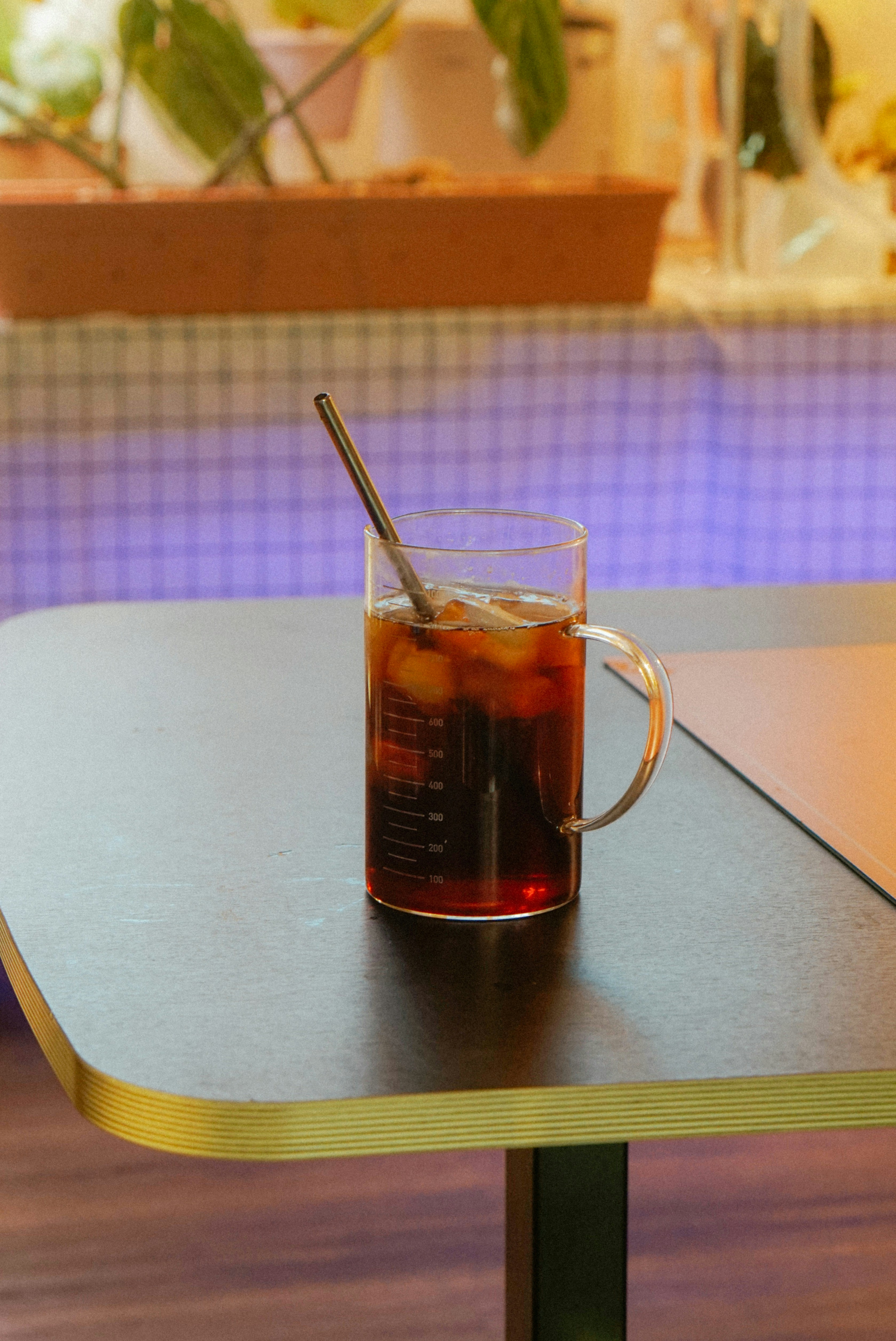 Iced coffee with a spoon in a glass mug