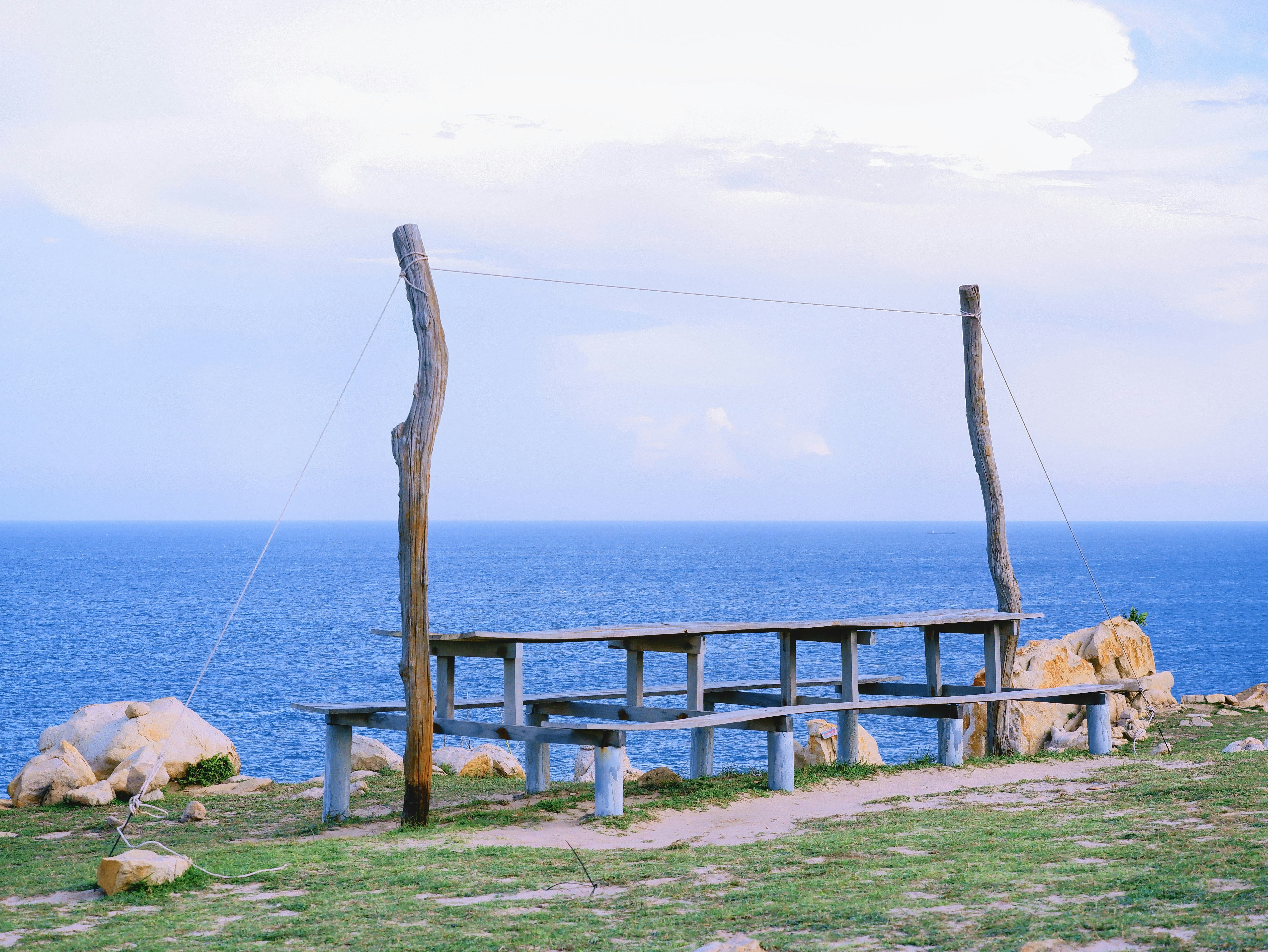 Wooden benches on a cliff overlooking the ocean photo – Free Blue sky ...