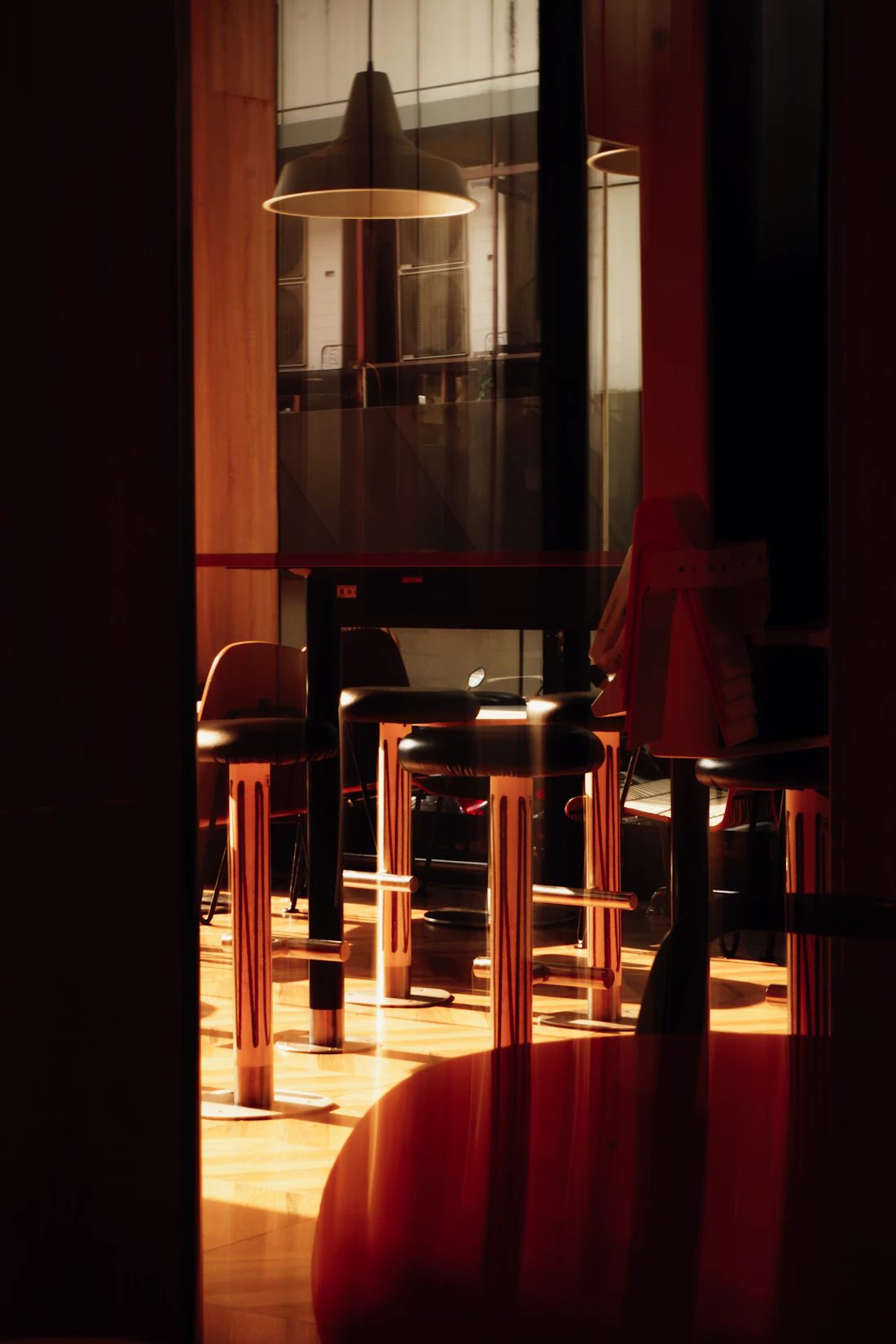 Bar stools and tables illuminated by warm light