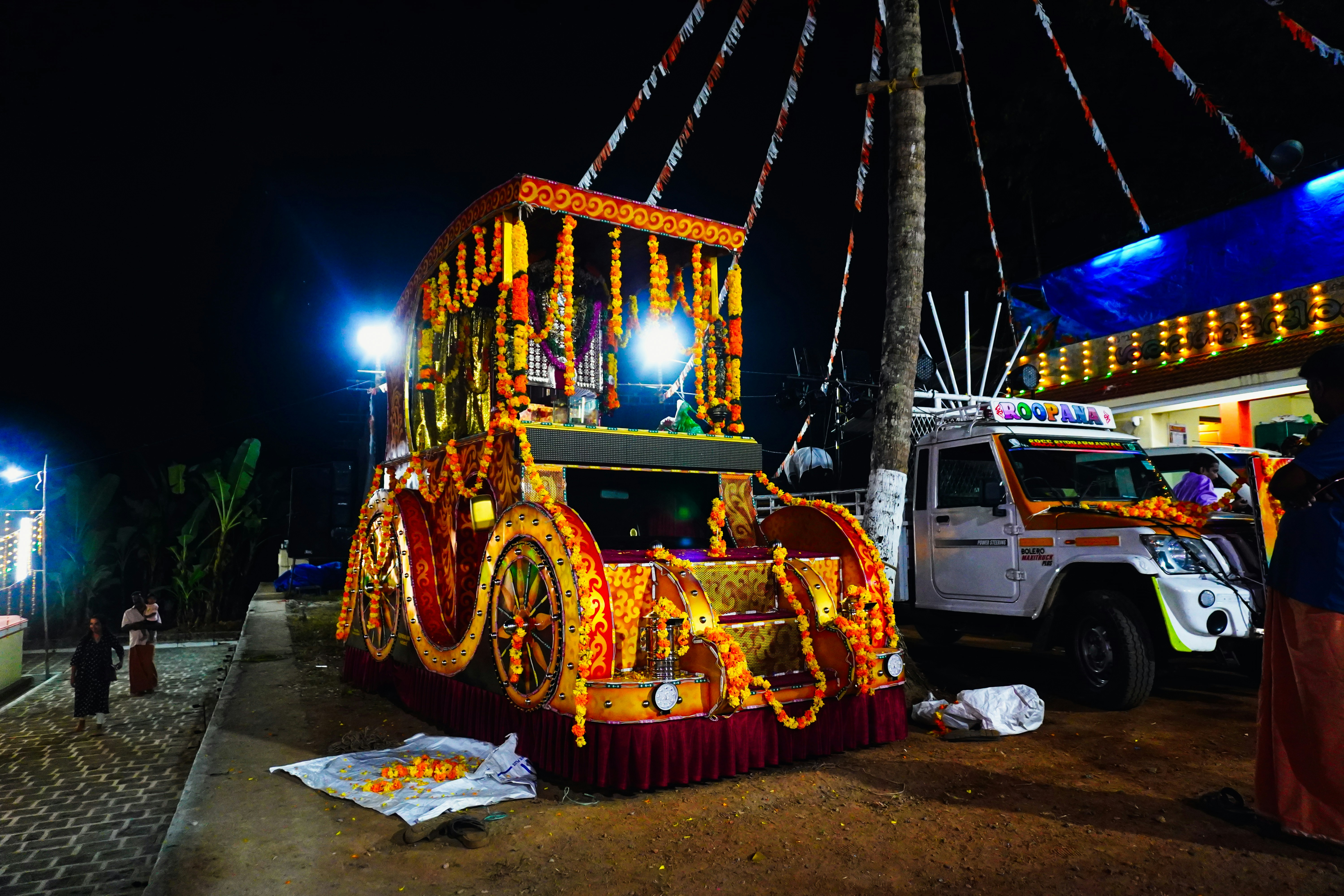 Ornate decorated float with flowers at night