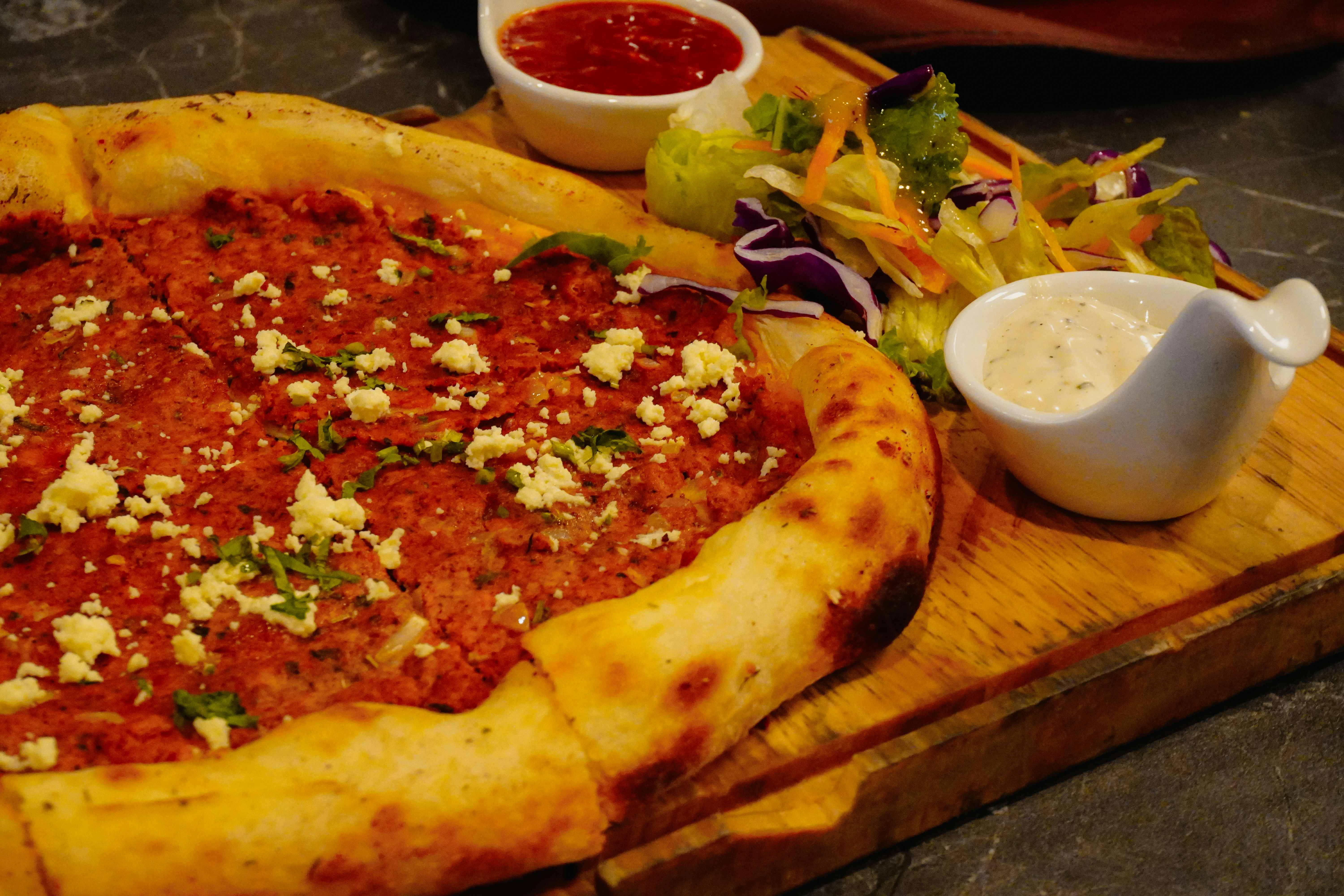 A delicious turkish pide with salad and dips