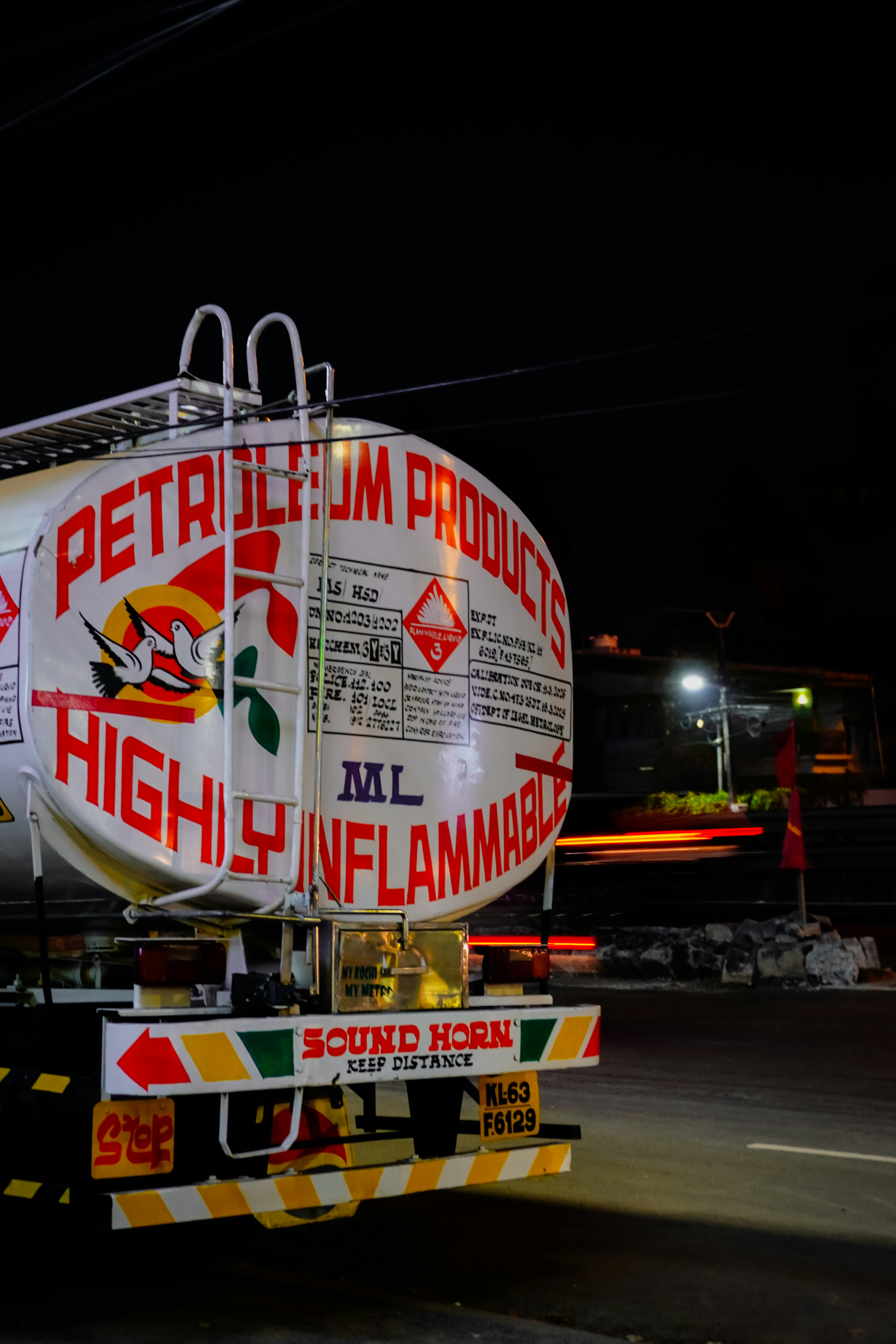 Tanker truck with "petroleum products" and "highly inflammable" labels.