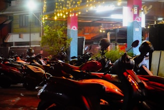 Motorcycles parked in a dimly lit area at night.