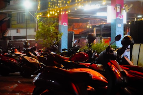 Motorcycles parked in a dimly lit area at night.