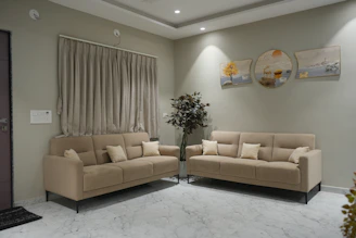 Two beige sofas in a modern living room.