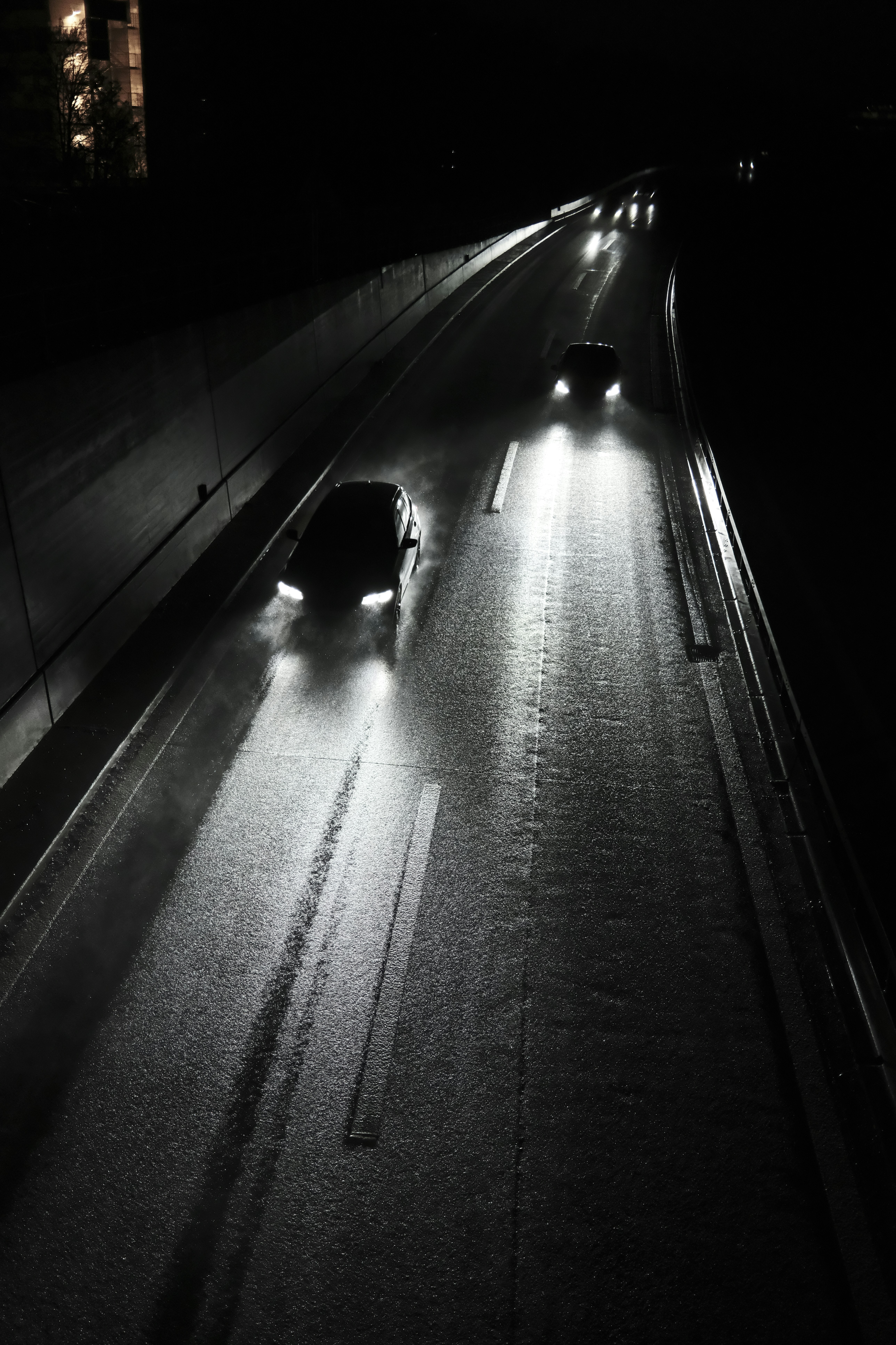 Cars driving on a wet road at night