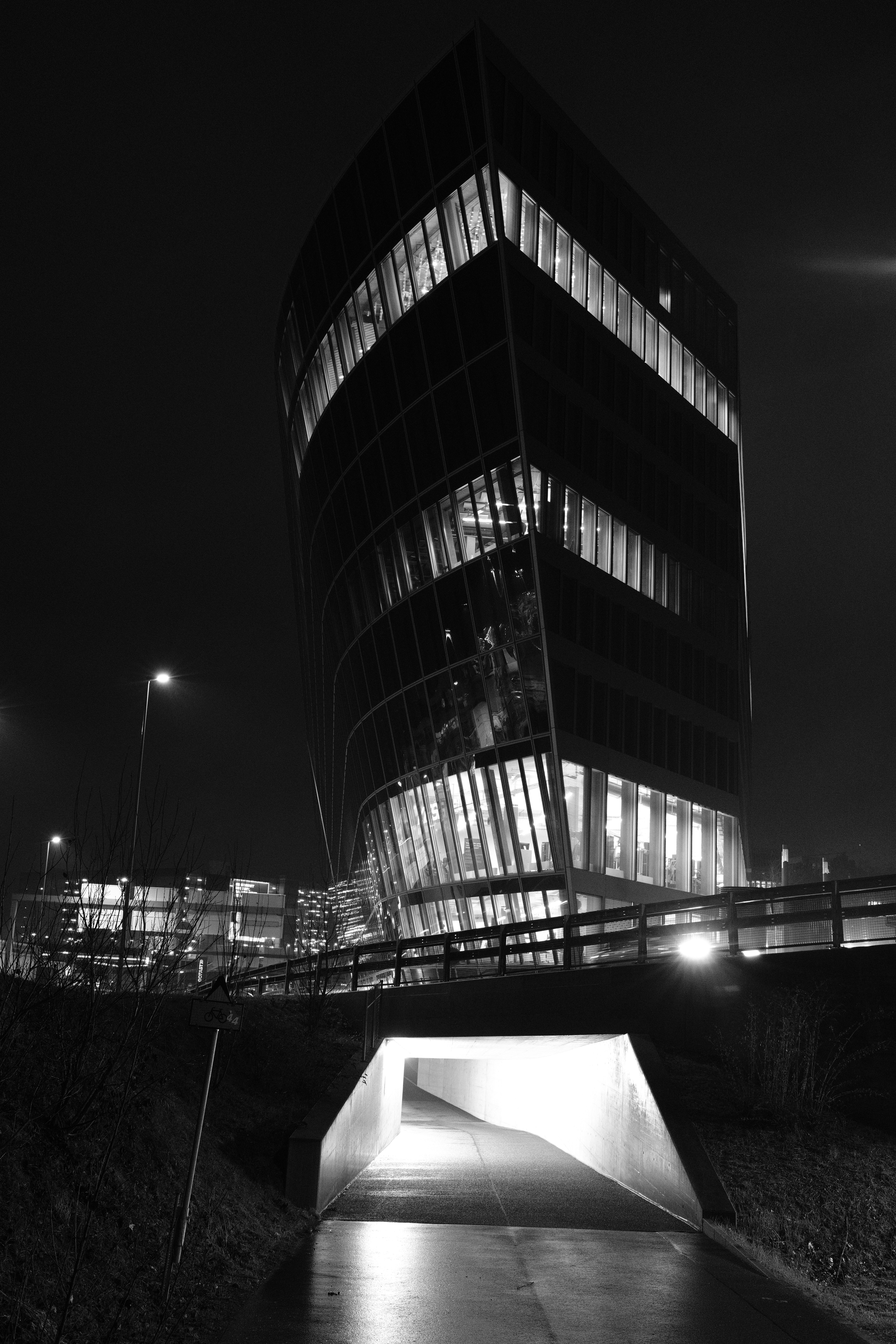 Modern building illuminated at night with underpass