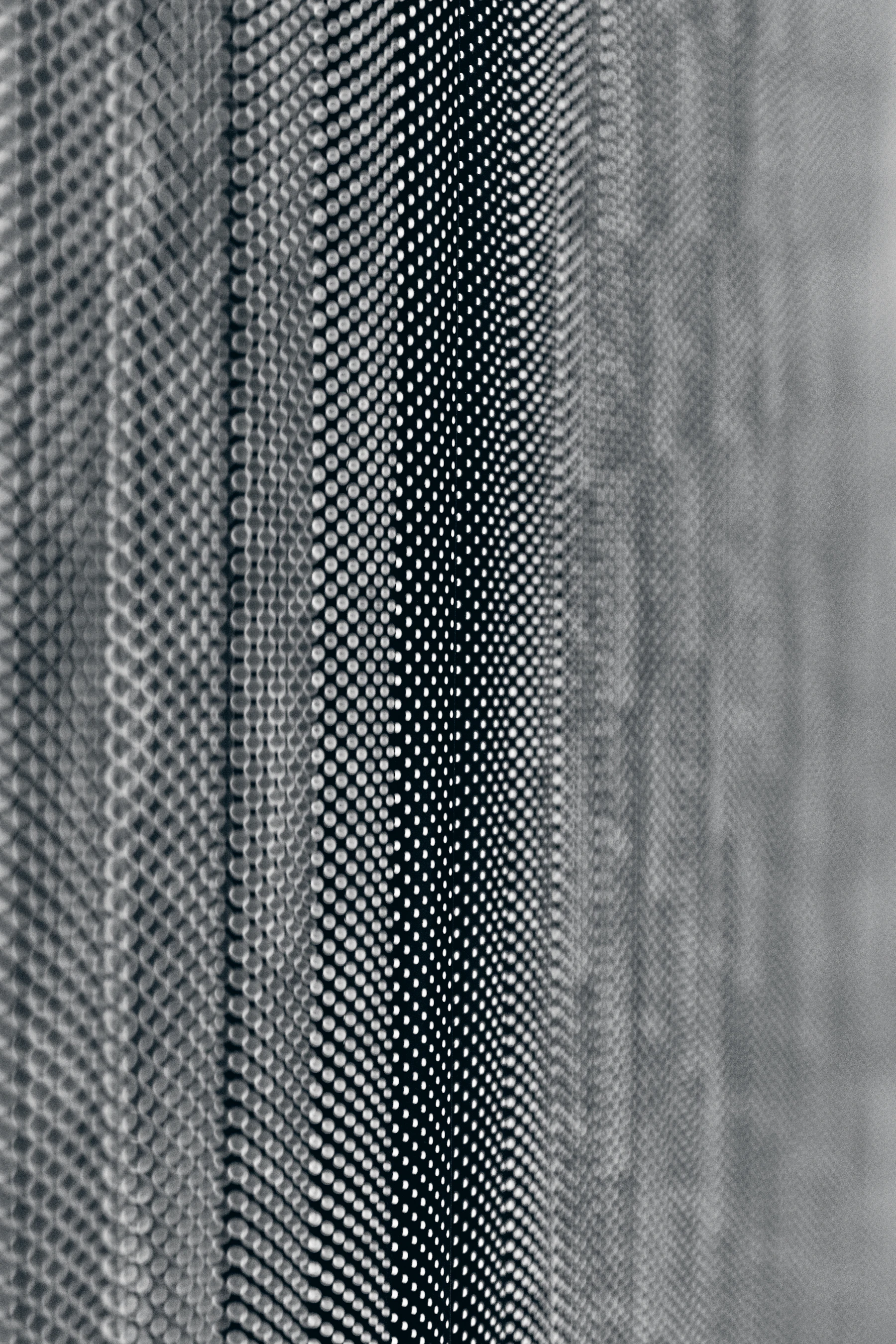 Grayscale pattern of dots and lines across a textured surface