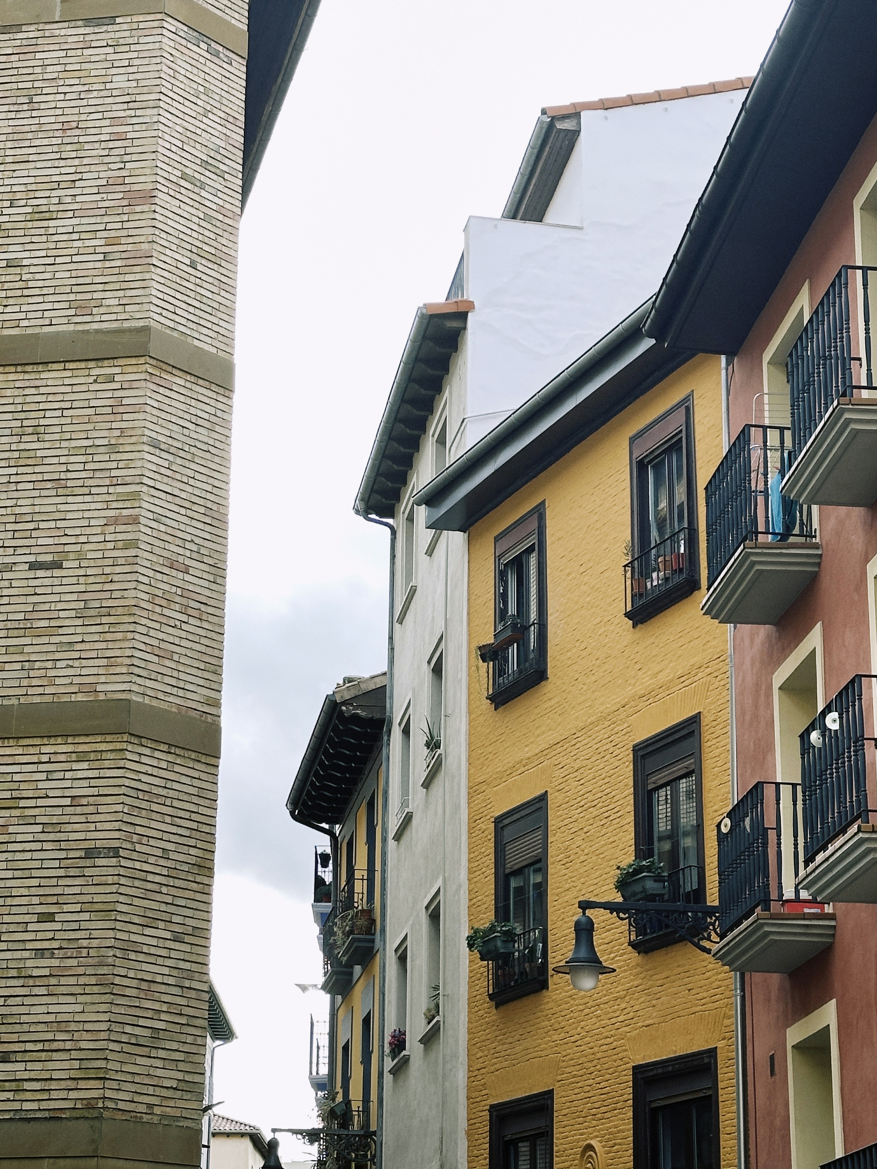 Colorful buildings with balconies on a cloudy day