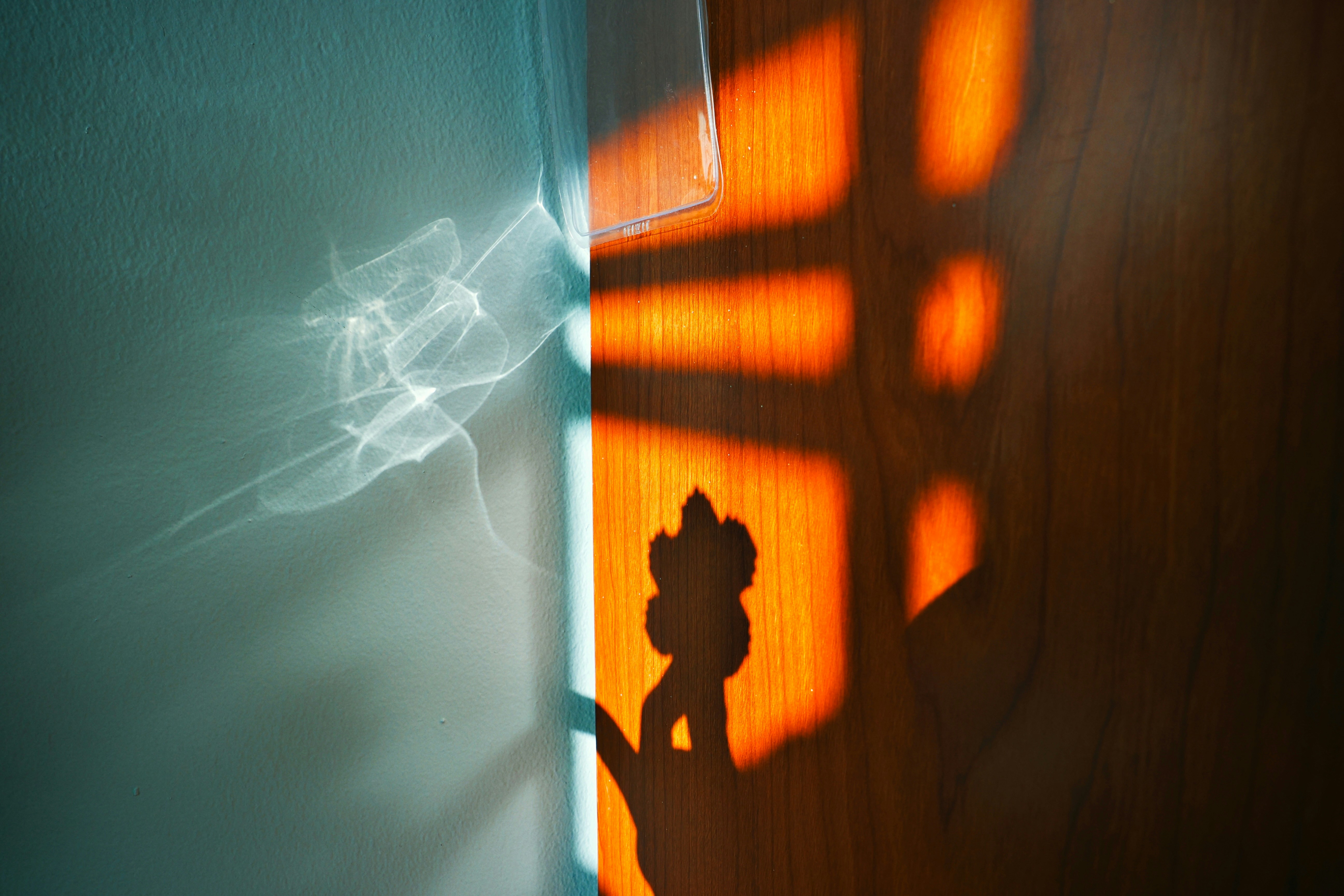 Light and shadow play on wall with smoke.