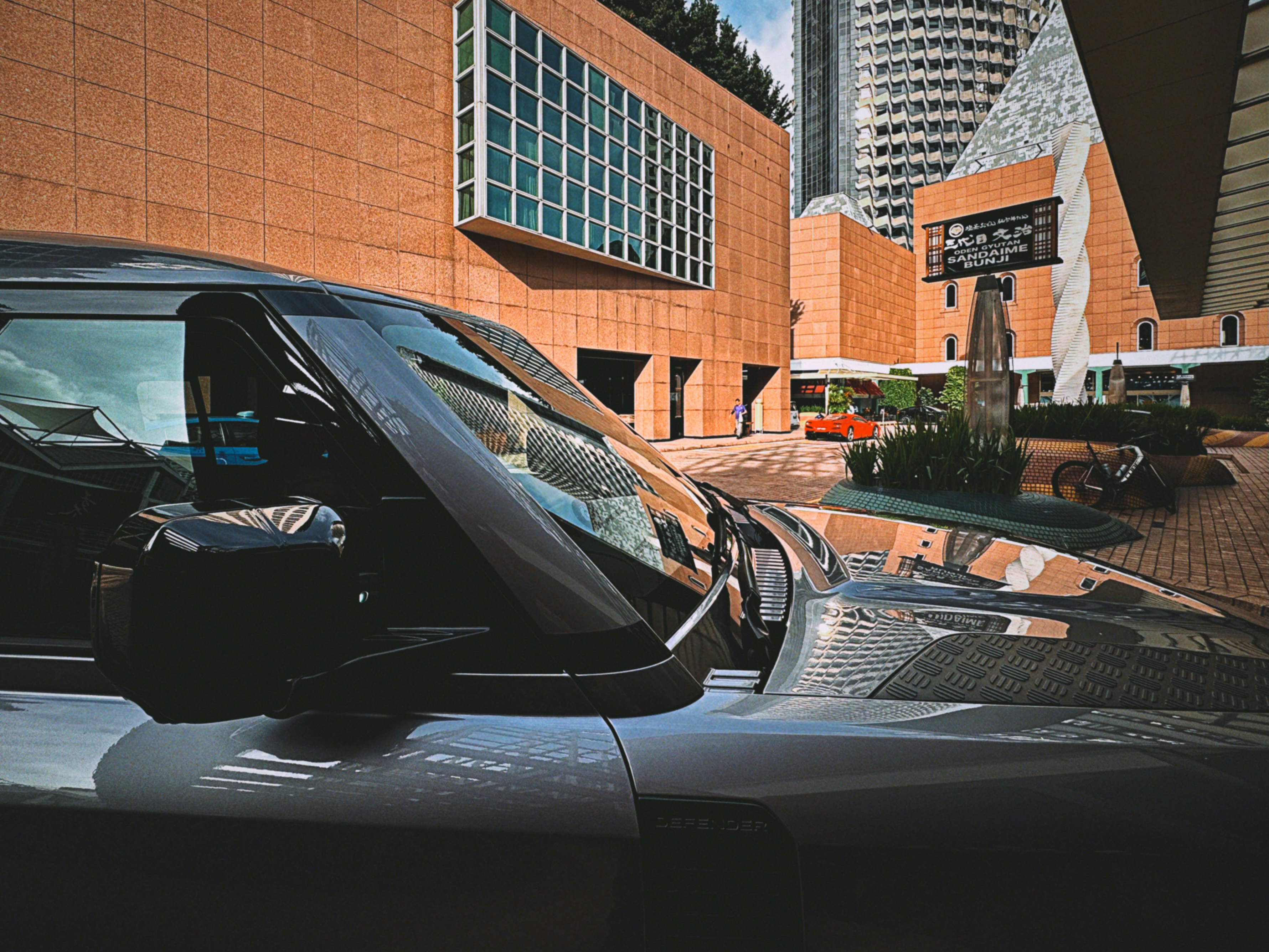Modern car parked outside brick building
