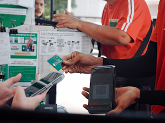 Customer paying with smartphone and credit card at checkout.