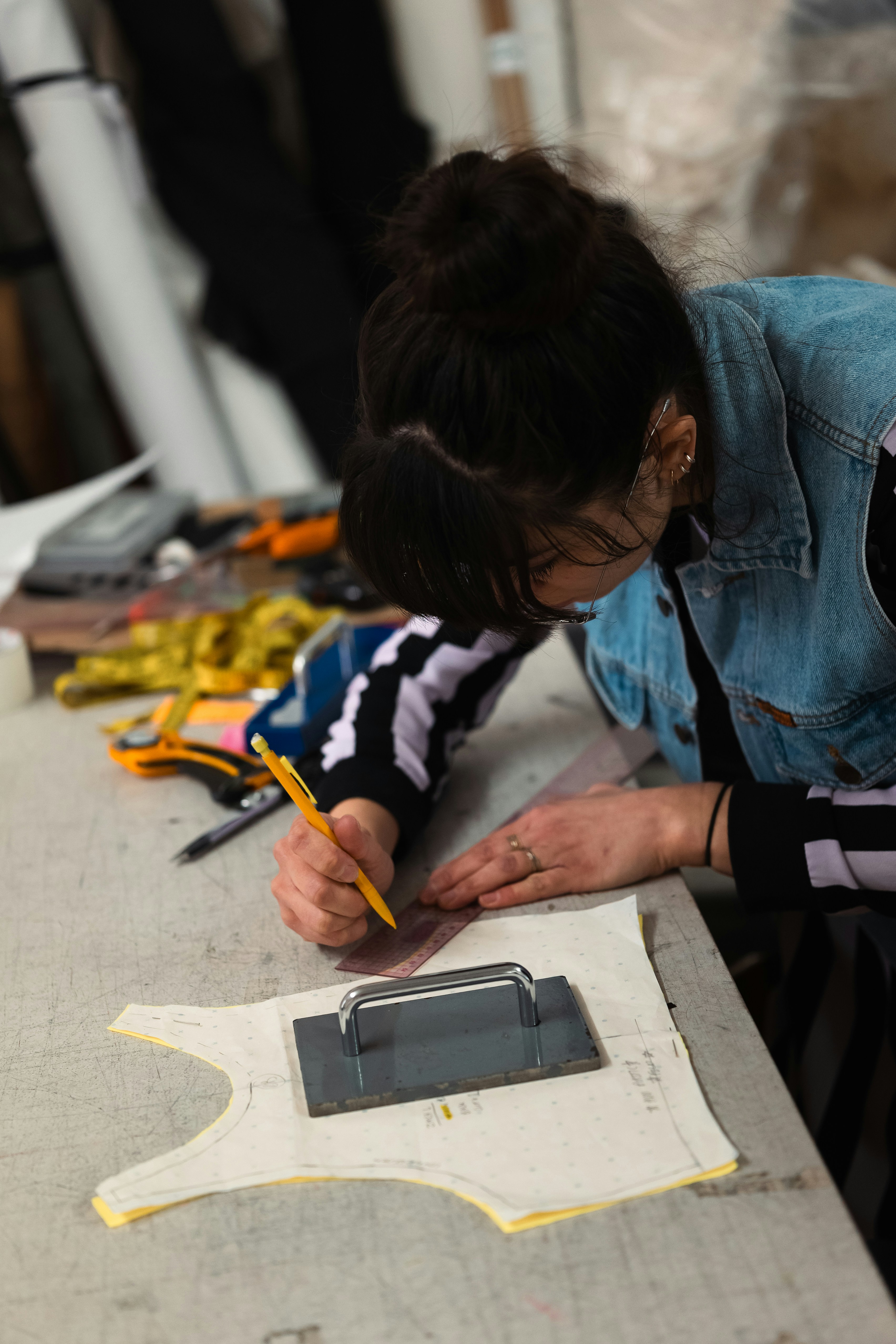 A person drawing on a clothing pattern