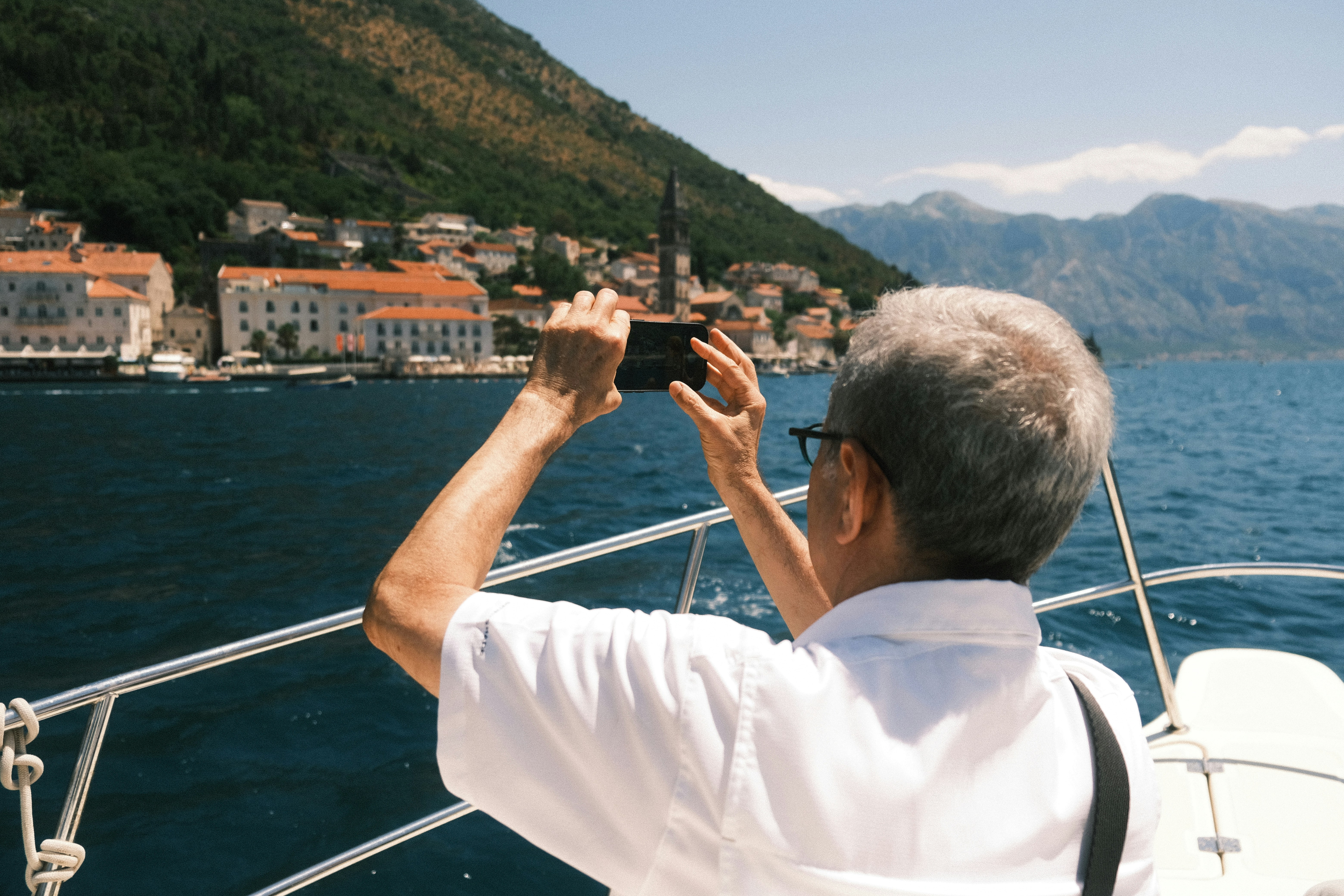 The old man photographing the city of Perast, Montenegro.