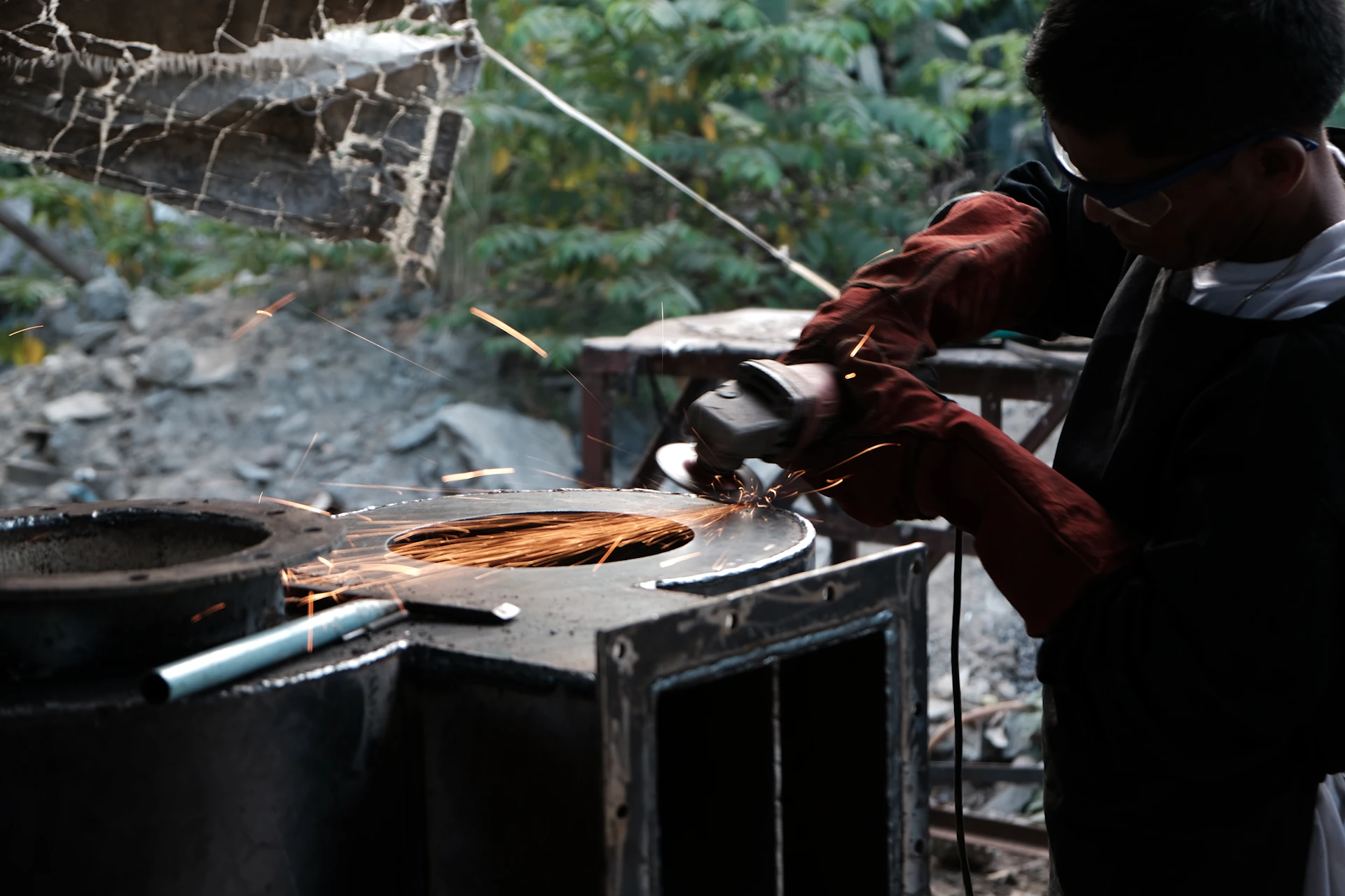 Man grinding metal with a power tool