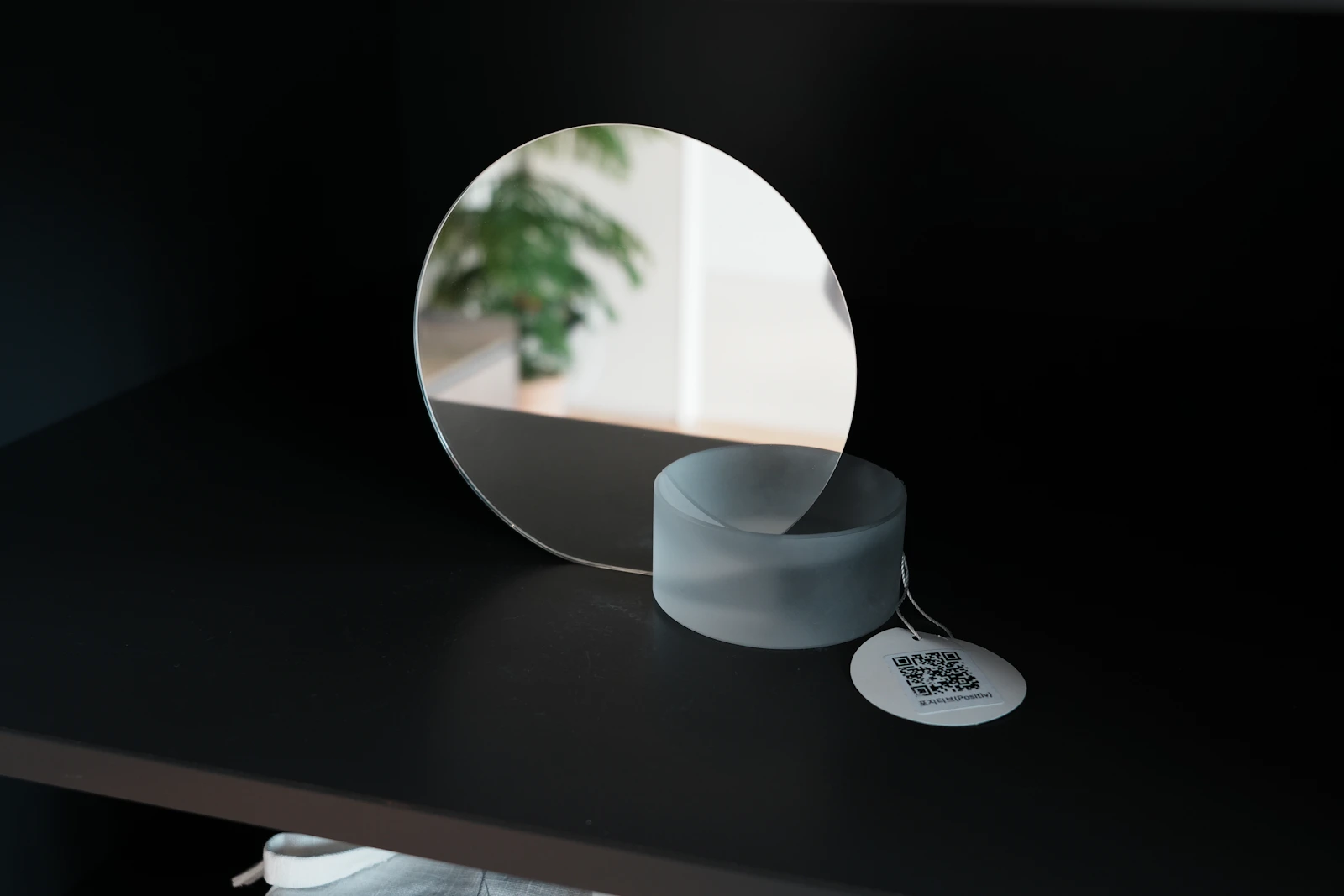 Round sculptural mirror styled in a minimalist interior