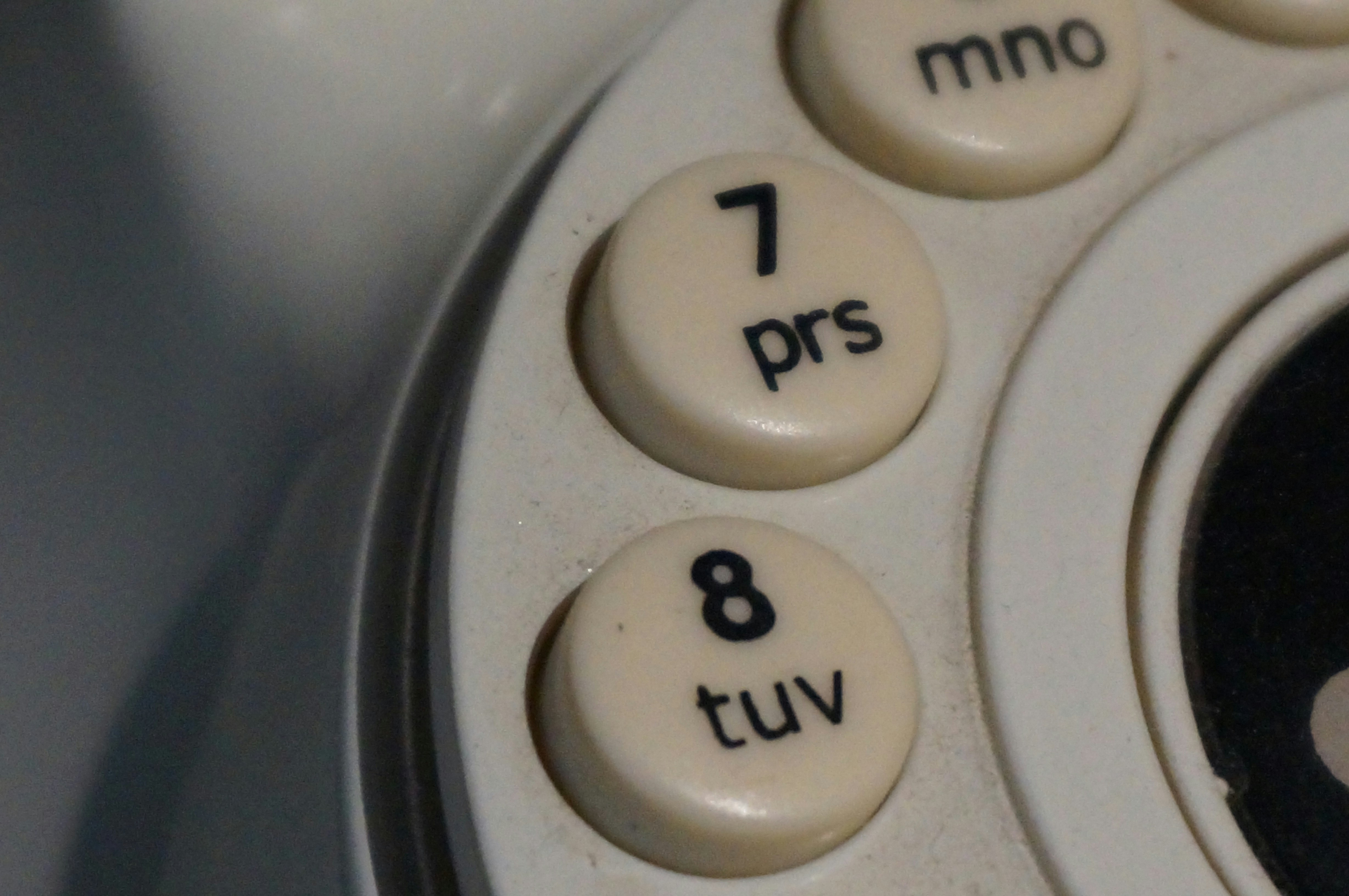 Close-up of old rotary phone dial buttons.