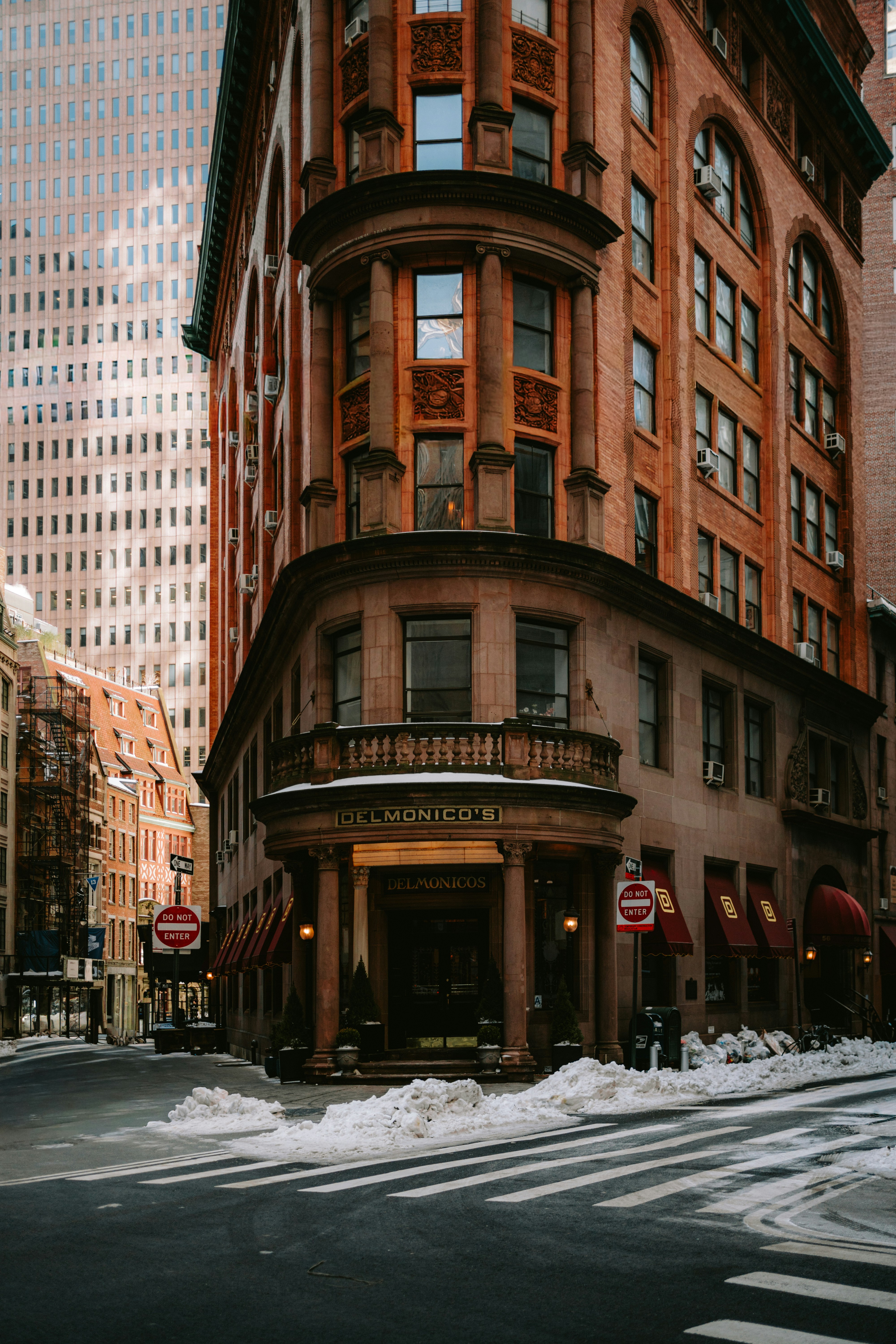 Ornate building corner on a snowy city street.