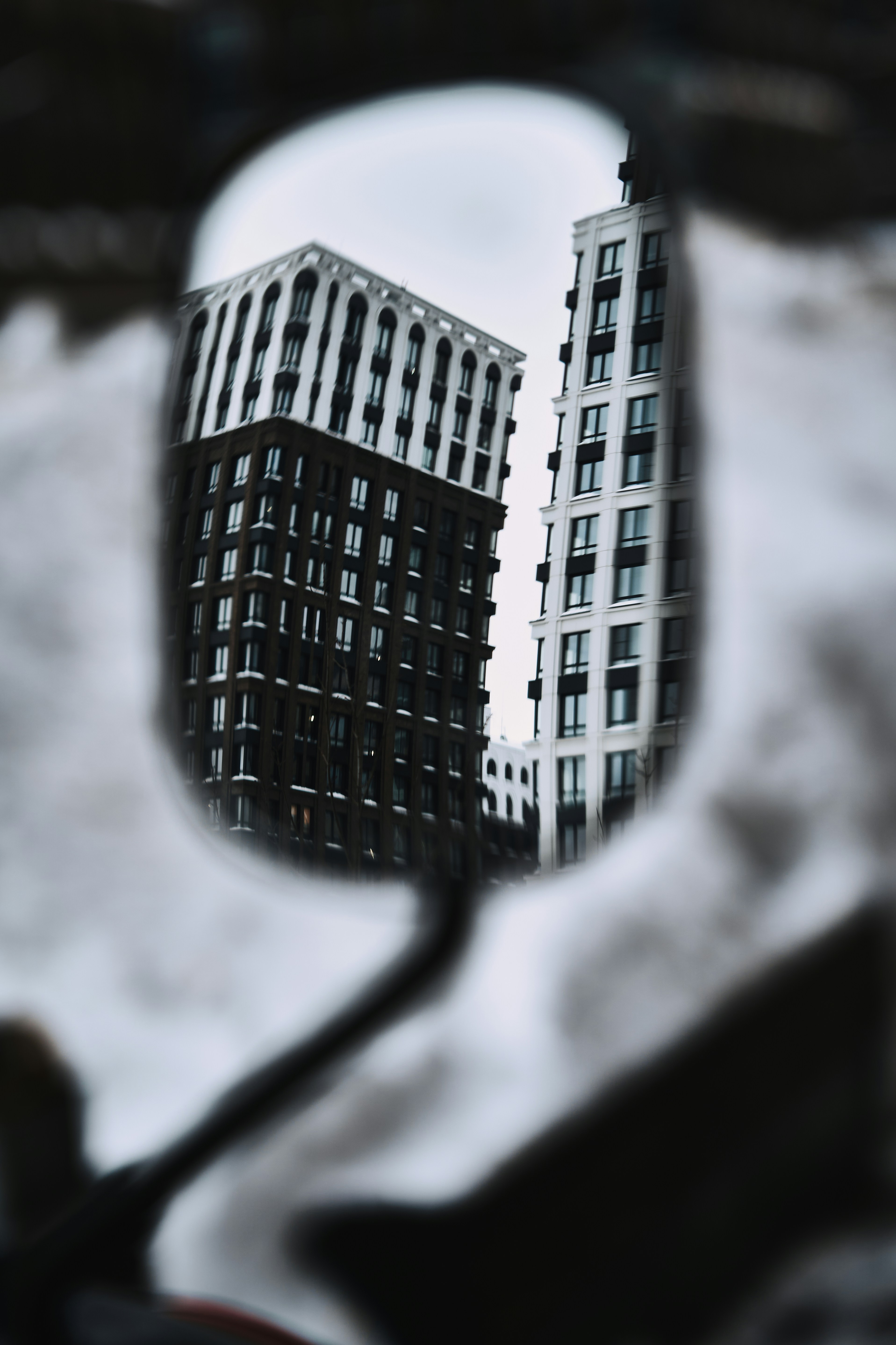 Modern apartment buildings reflected in a mirror.