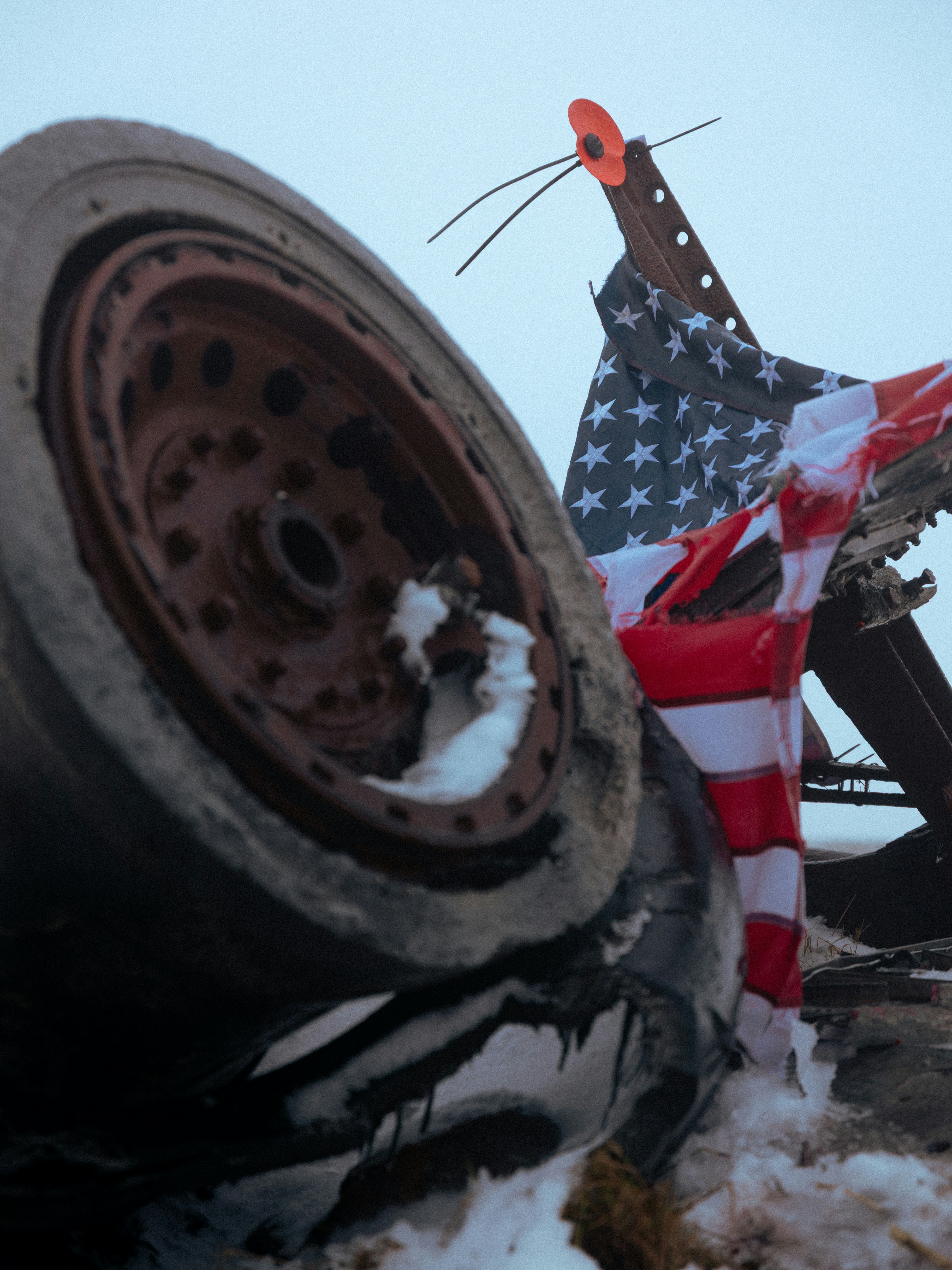 Tire and american flag on rusty metal structure