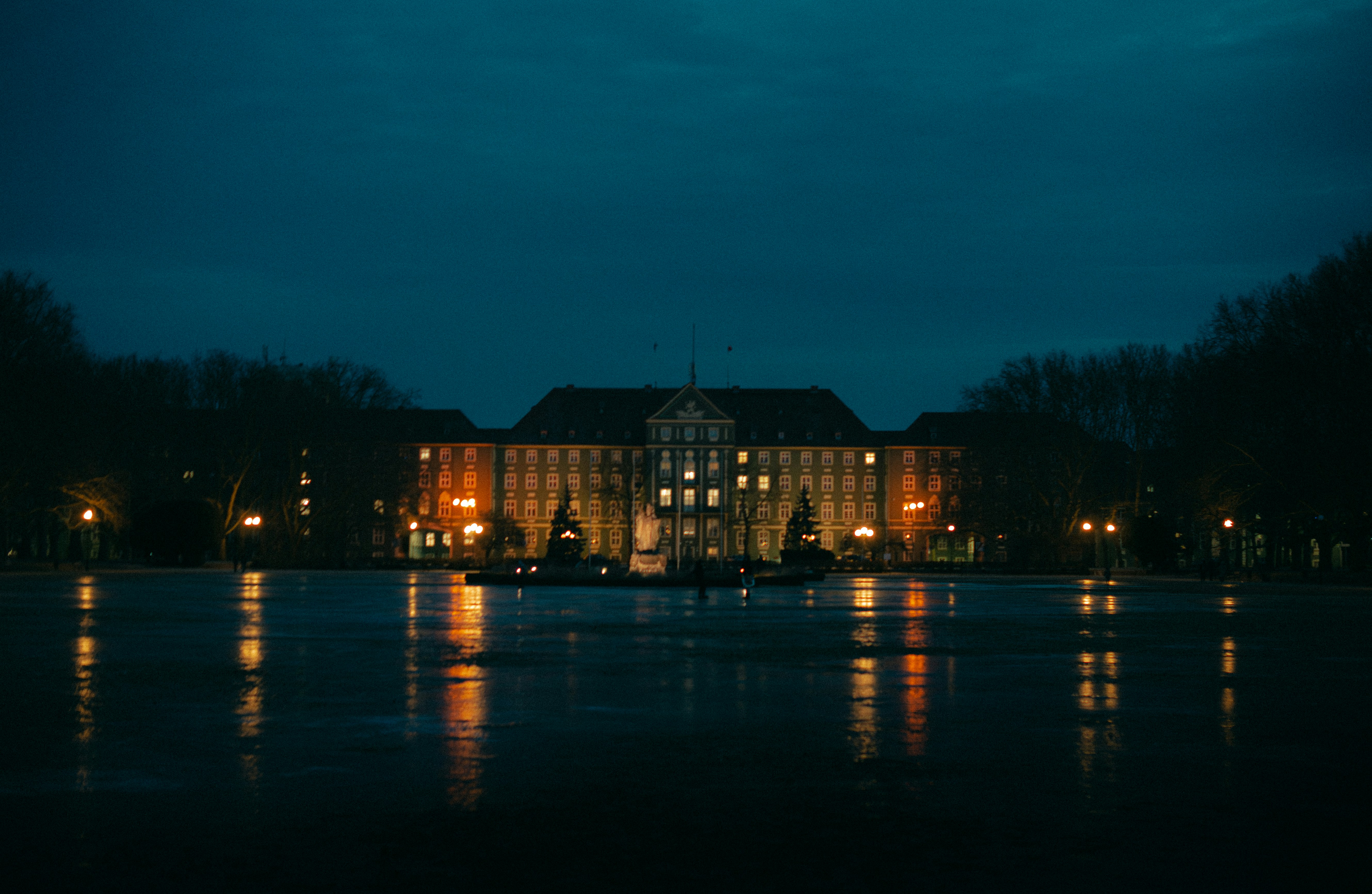 Building reflected in water at dusk
