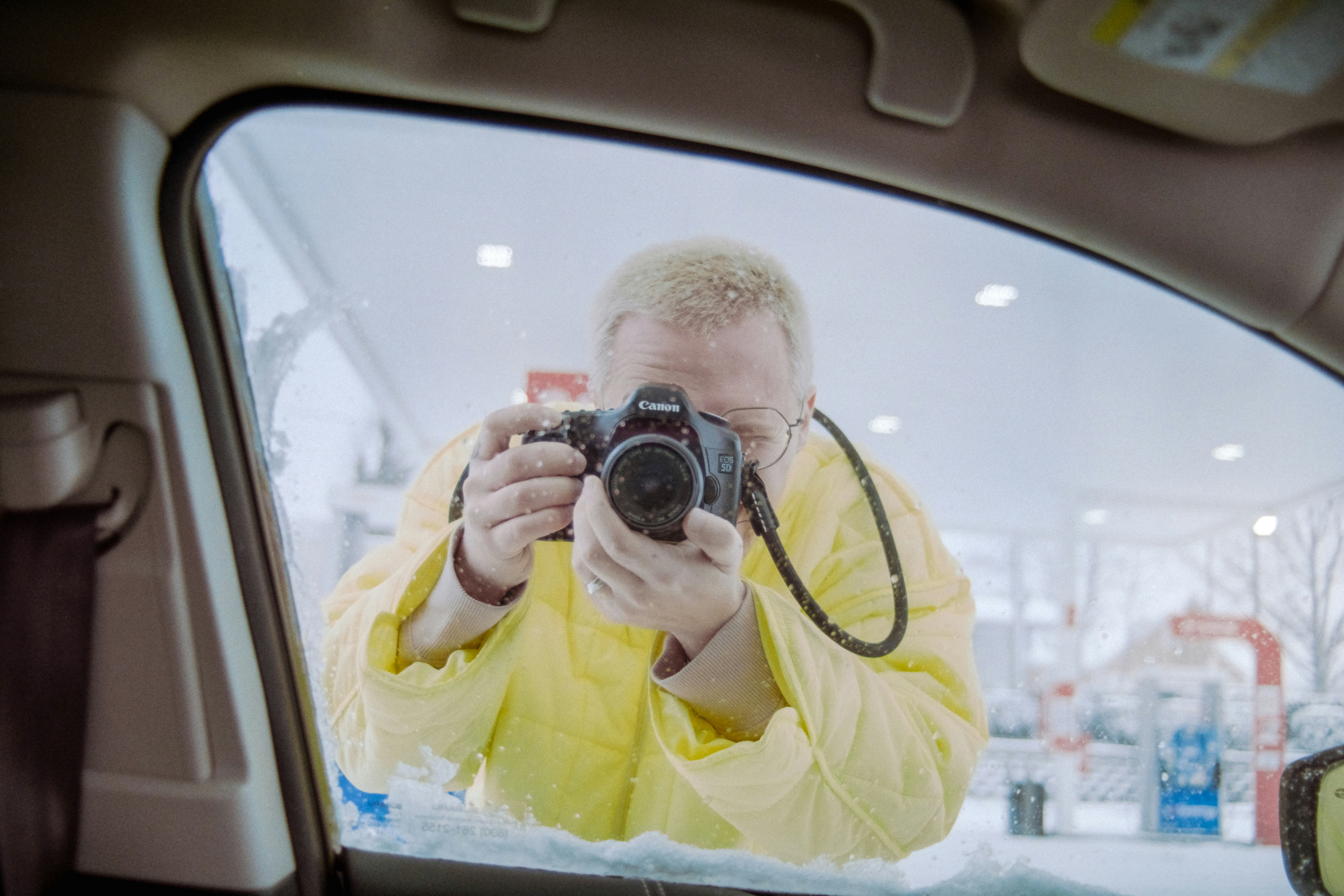 Man in yellow suit taking photo with dslr camera
