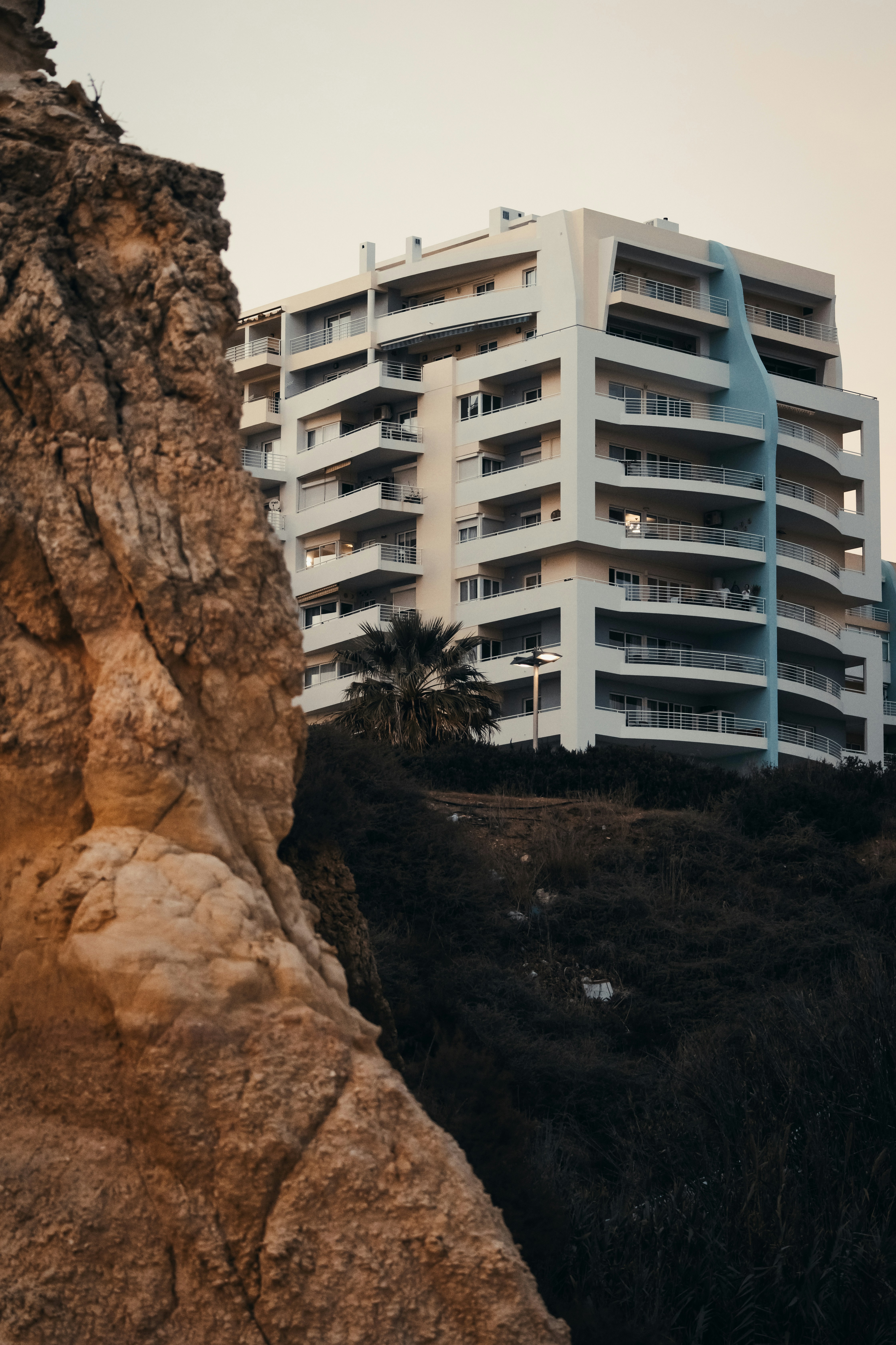 Modern white building on a rocky hillside