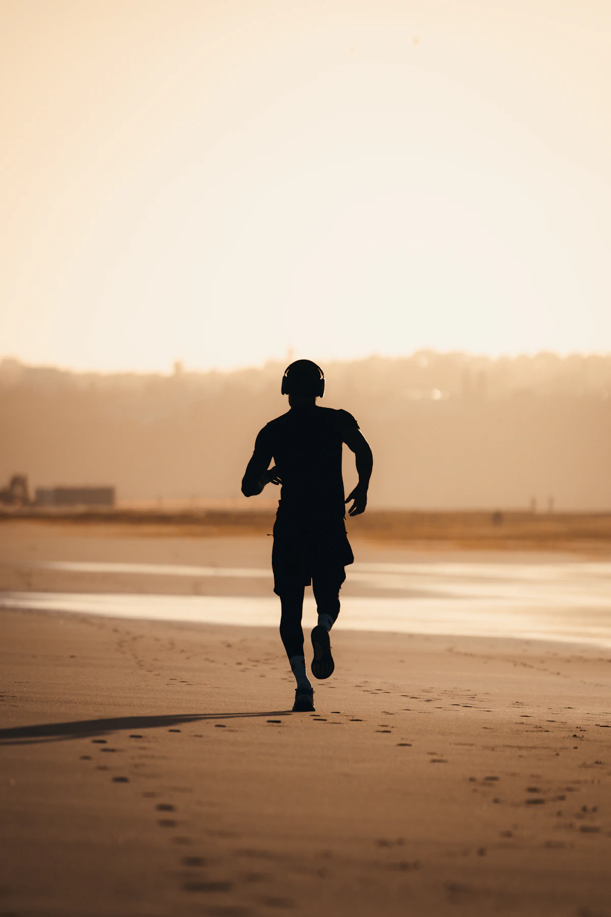 A runner on the beach at sunset