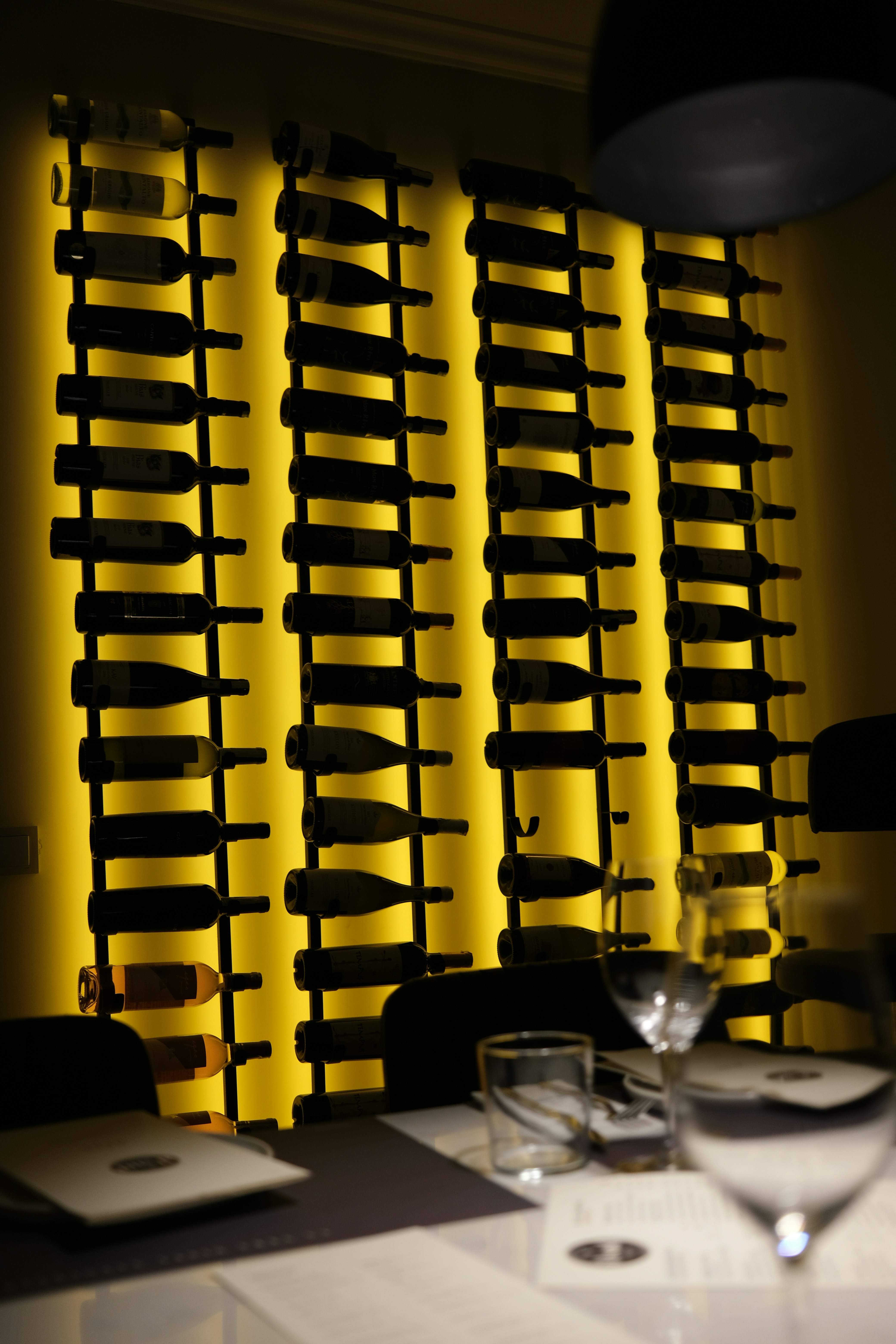 Wine bottles displayed on a backlit rack