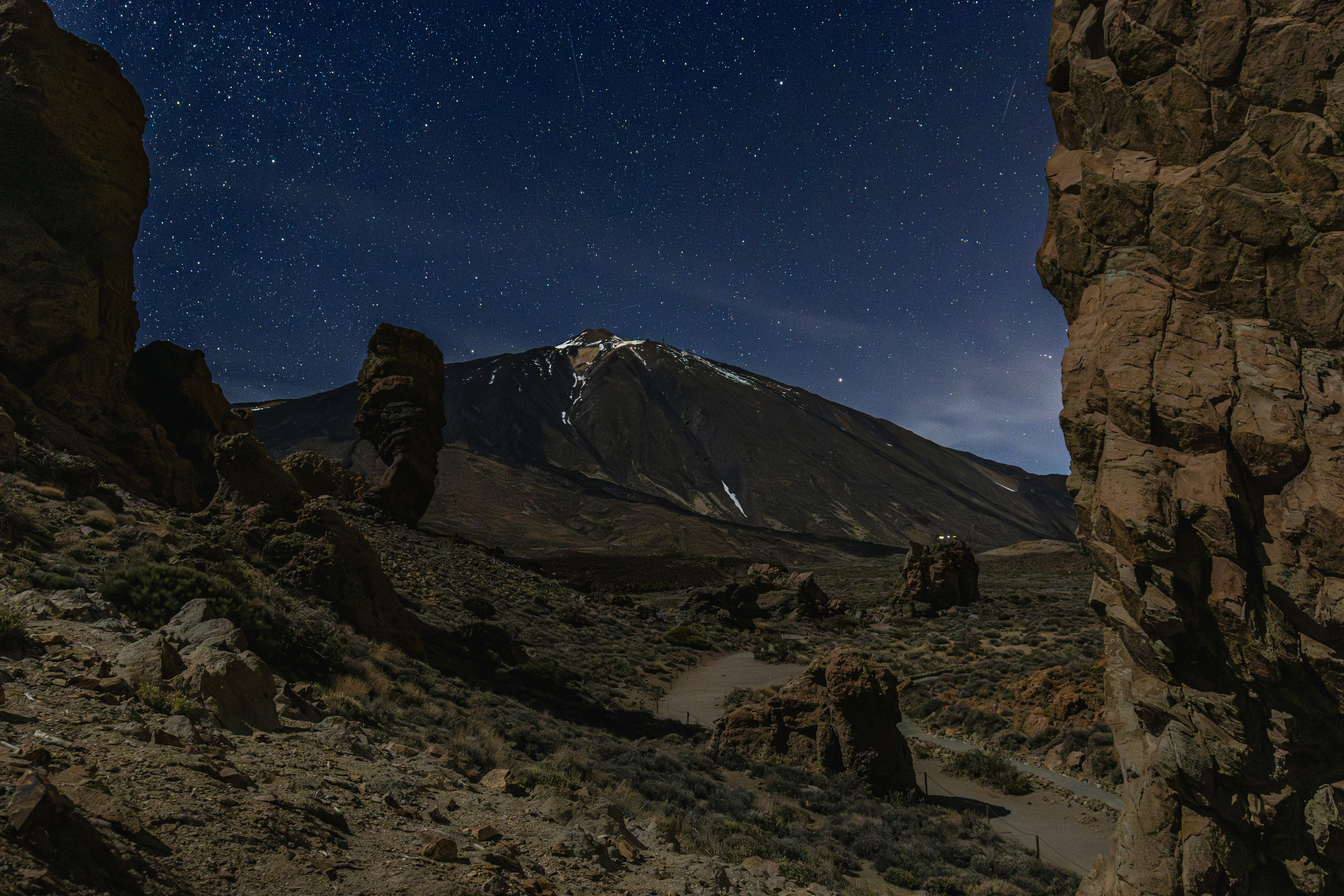 Mountain peak under a starry night sky