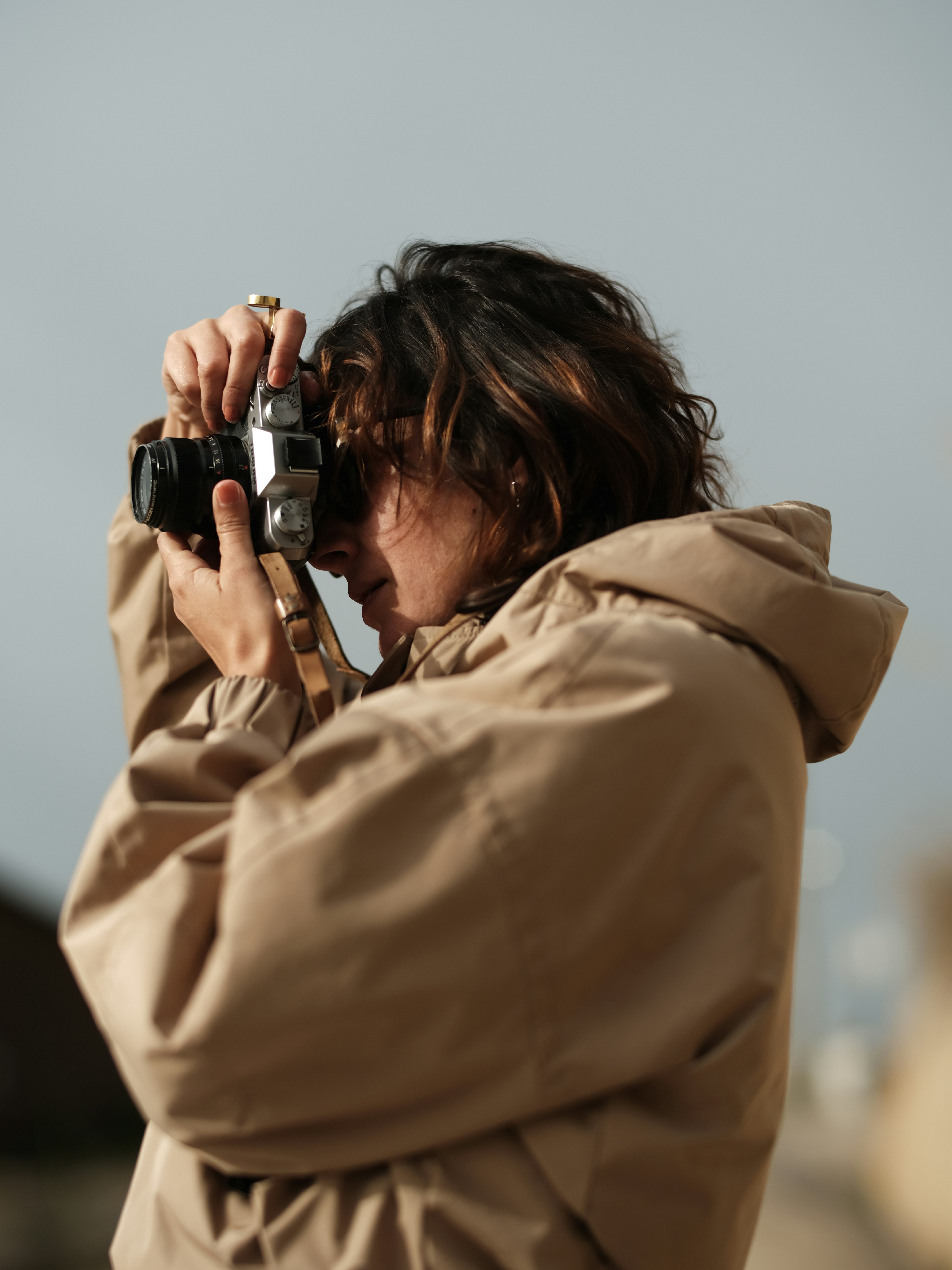 Woman with camera taking a photo outdoors