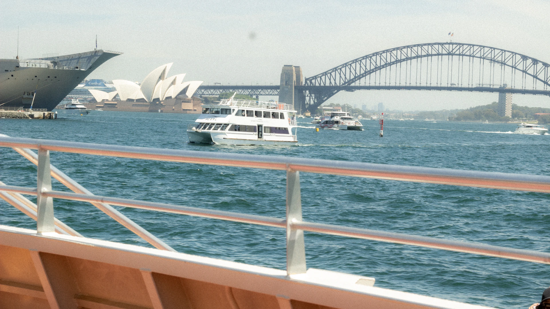 Boats on the water with sydney opera house and bridge.