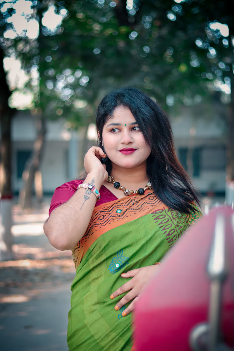Young woman in an emerald green handloom saree with beaded jewellery