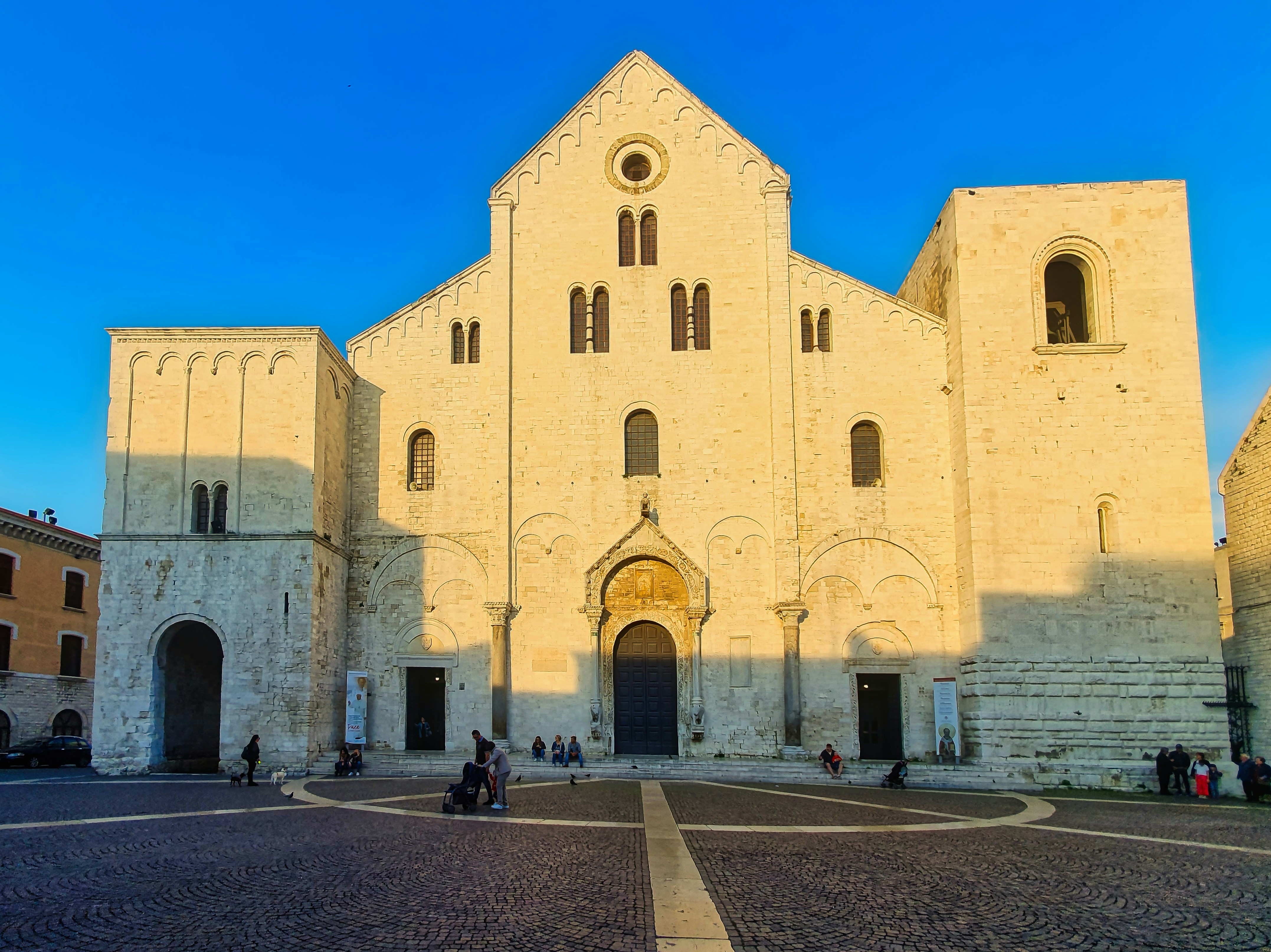 A grand stone cathedral stands under a clear blue sky.