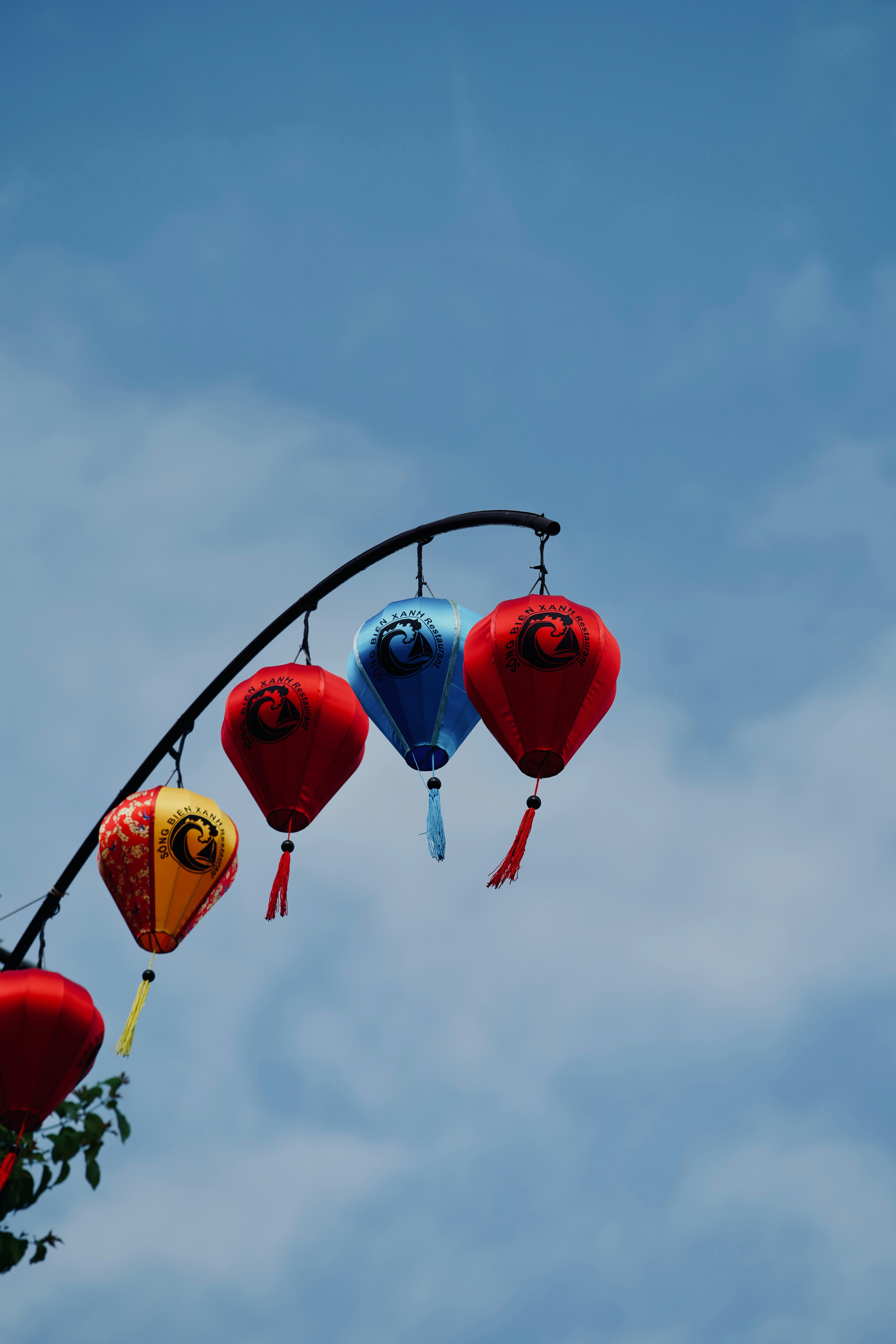 Colorful lanterns hanging against a cloudy sky
