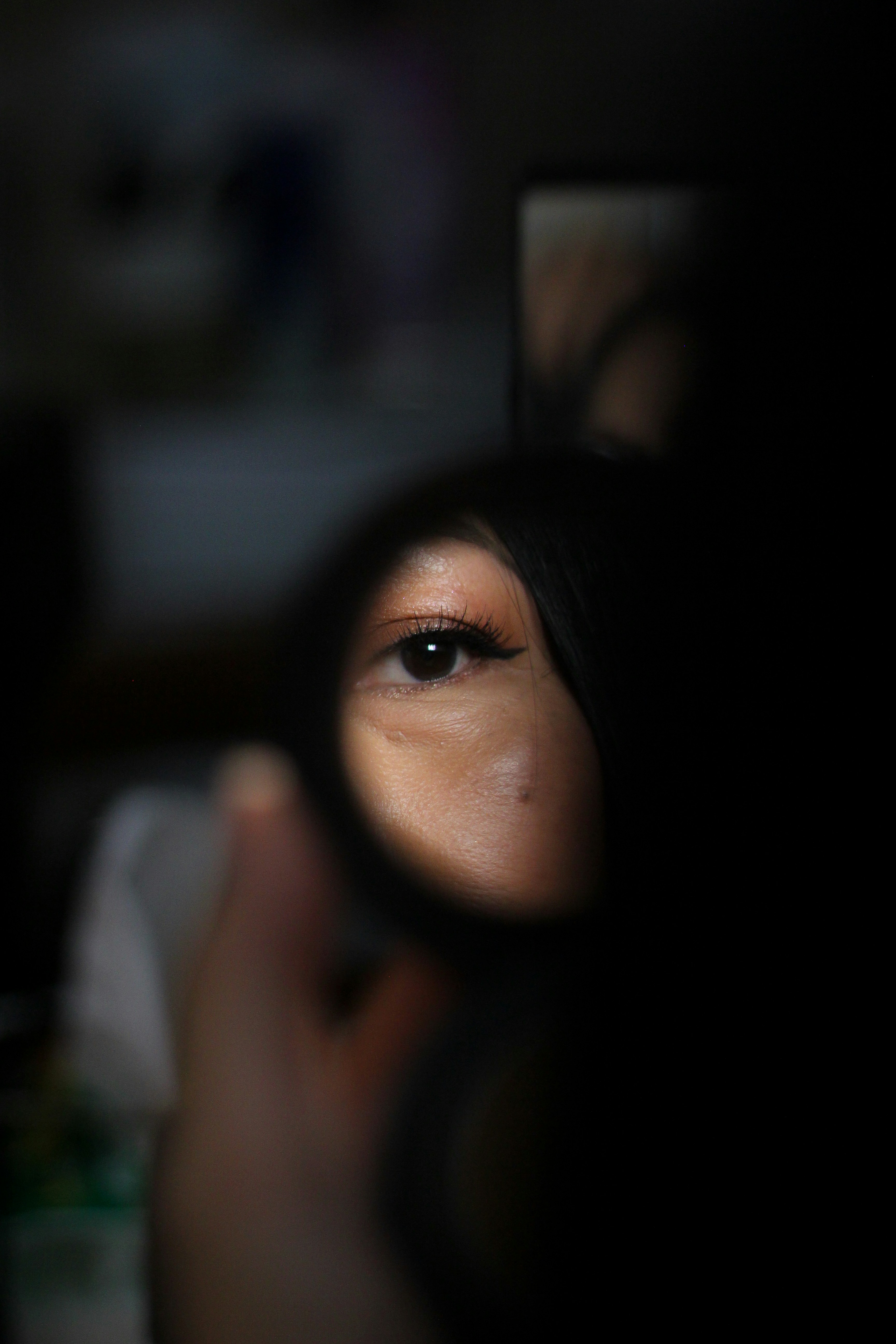 Close-up of a woman's eye reflected in a mirror