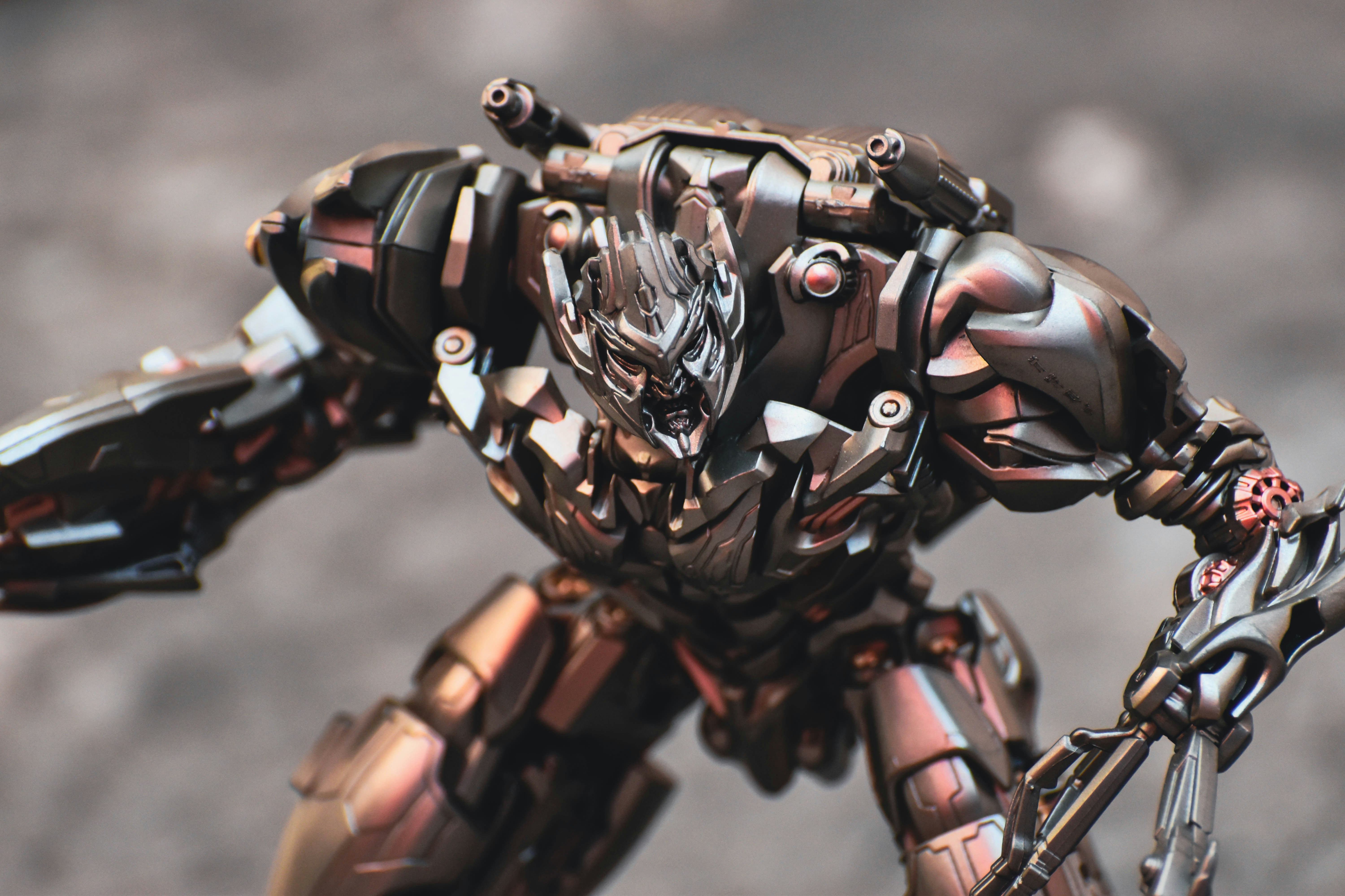 A detailed metallic robot warrior with sharp claws.