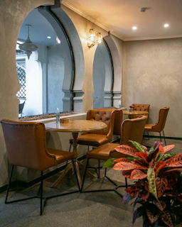Cozy cafe interior with leather chairs and round tables