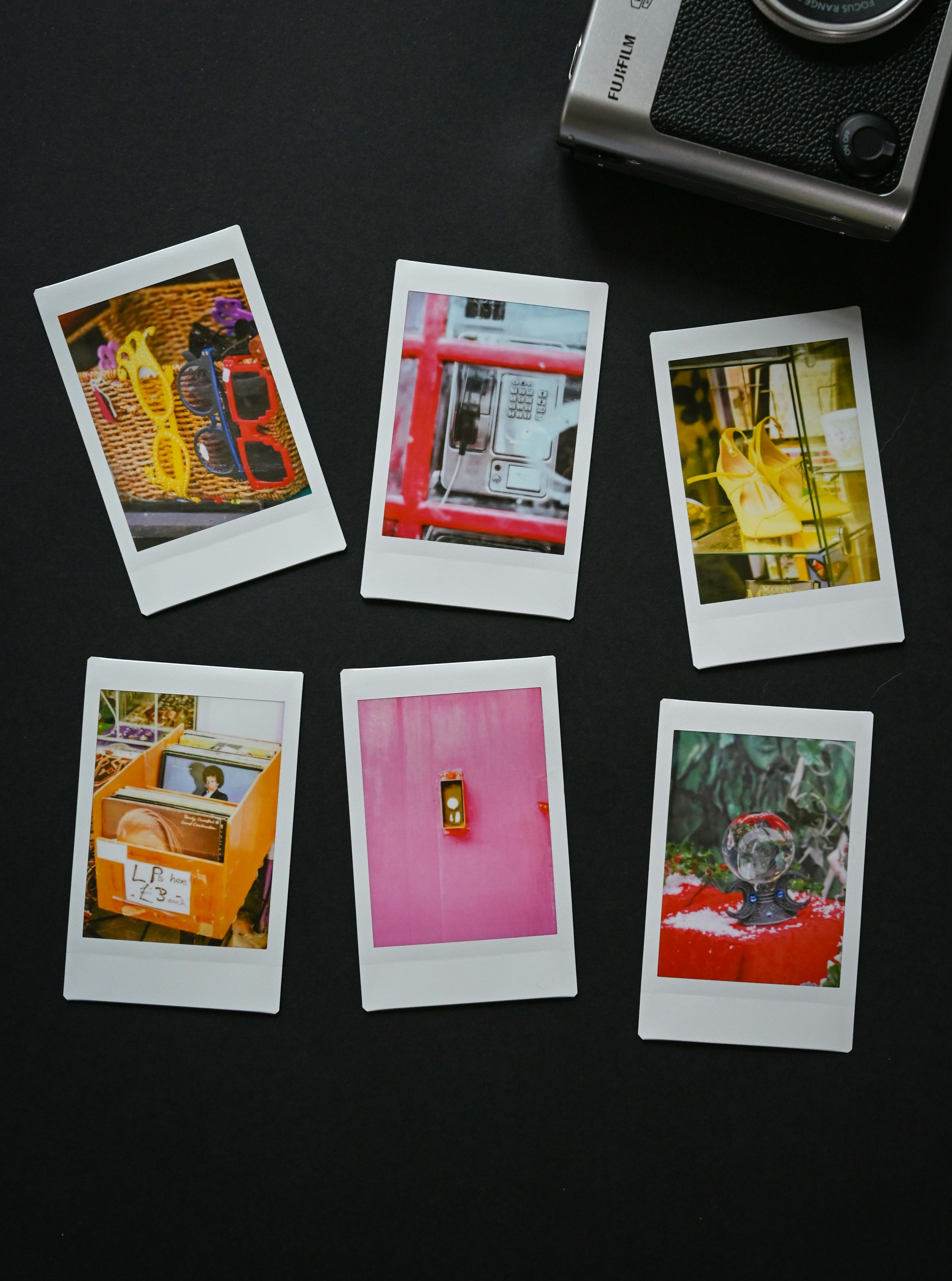 Six instant photos arranged with a camera