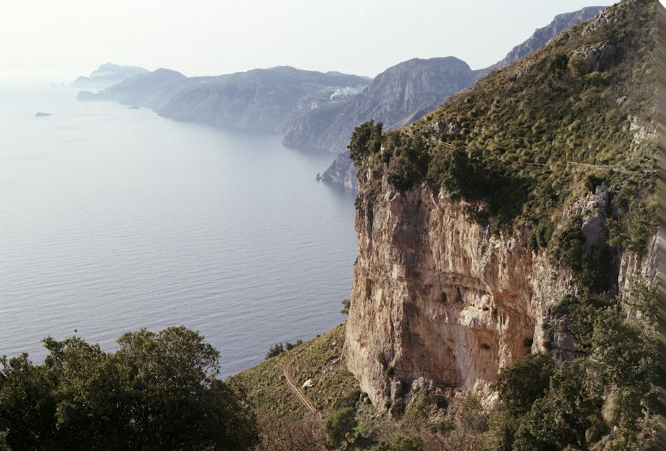 A small rocky cove with clear water at Marina di Praia
