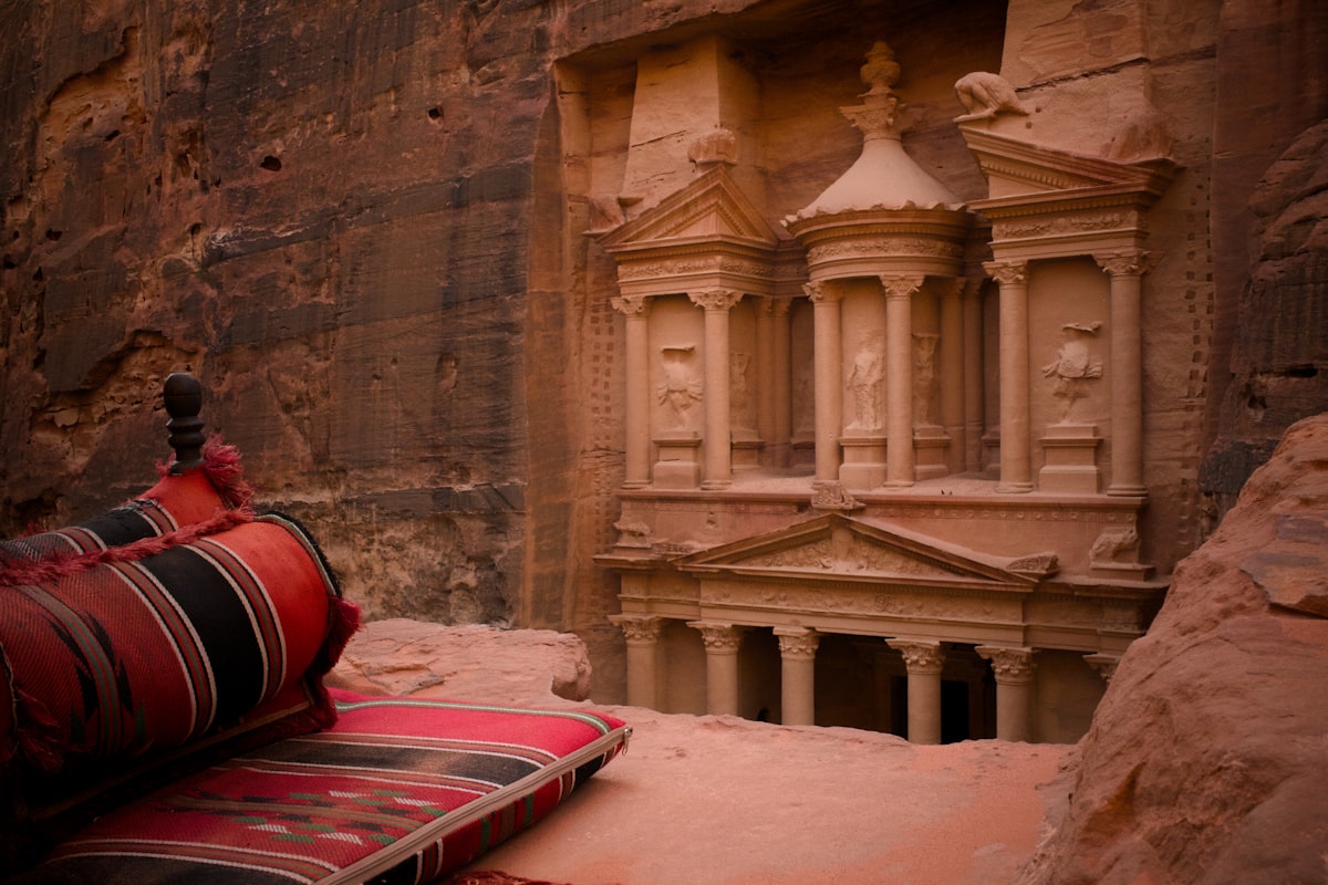 Petra Jordan — the iconic Treasury facade Al-Khazneh carved from rose-red sandstone framed by the narrow Siq canyon entrance