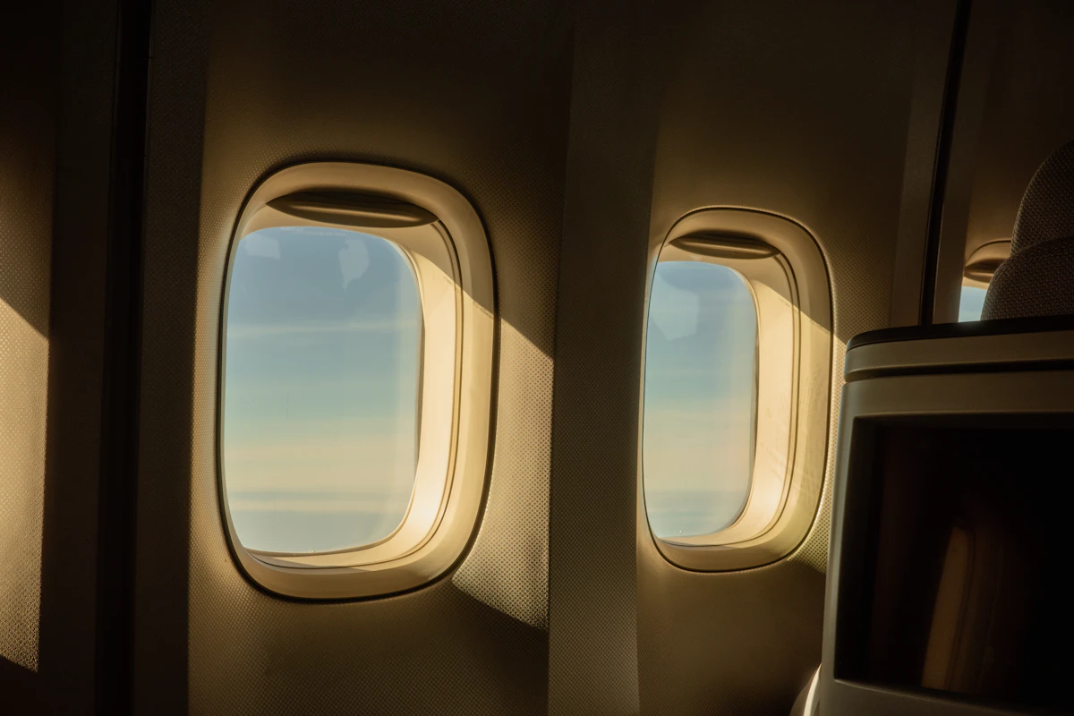 View from an airplane window above the clouds