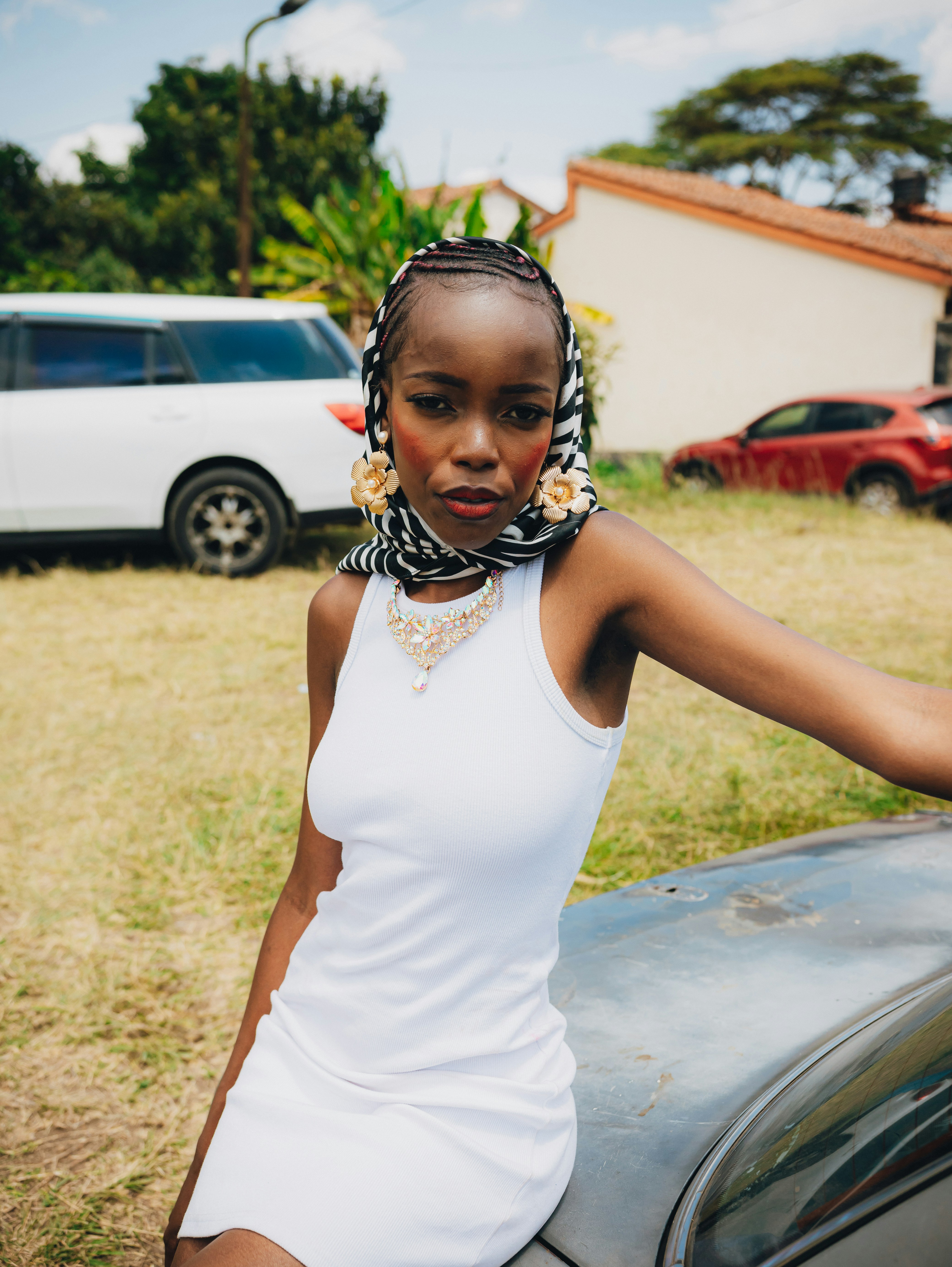 A young black woman with braided hair and jewelry