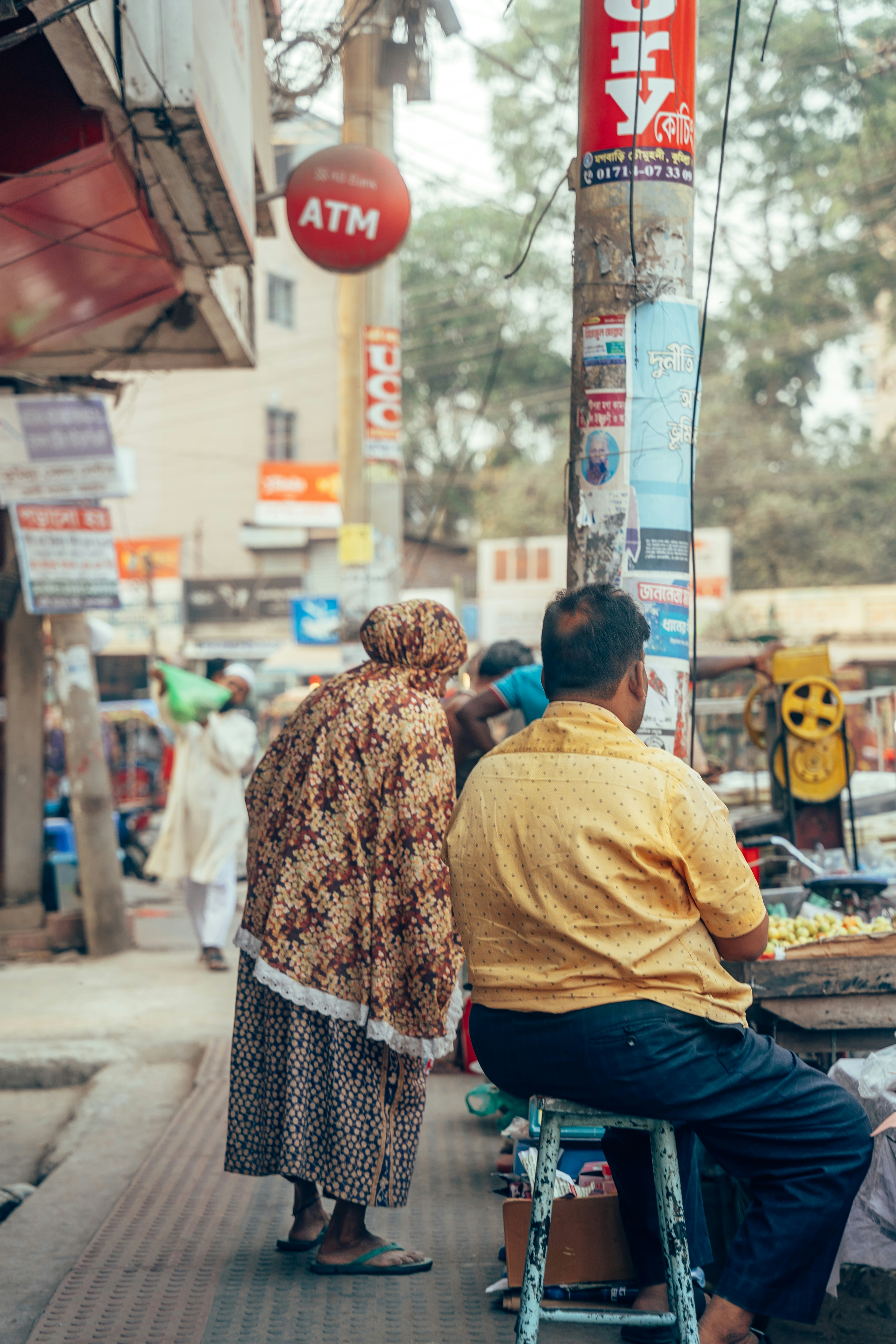 Zwei Personen, die auf einer Straße sitzen und stehen.