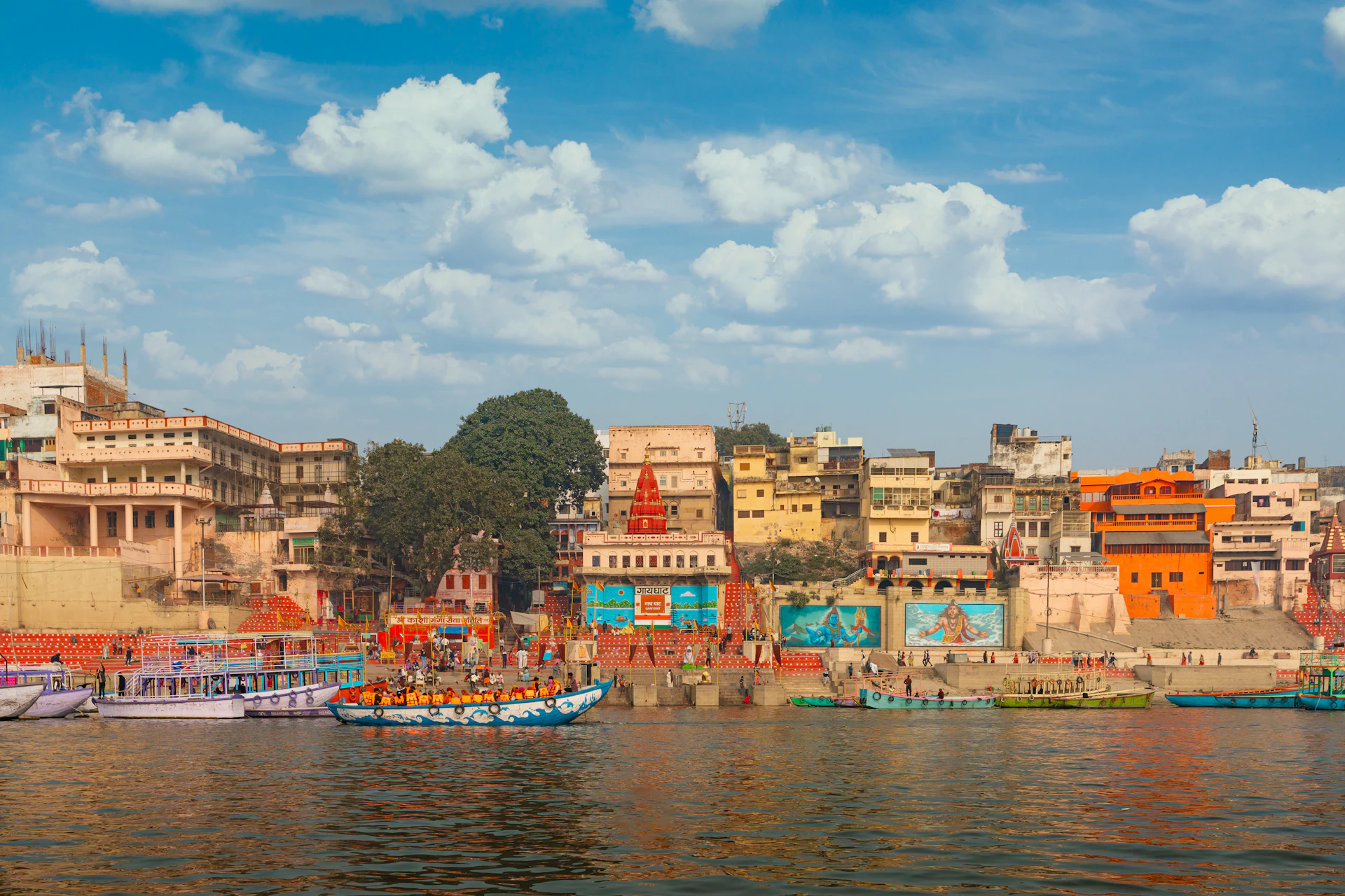 Boats on a river with buildings in the background