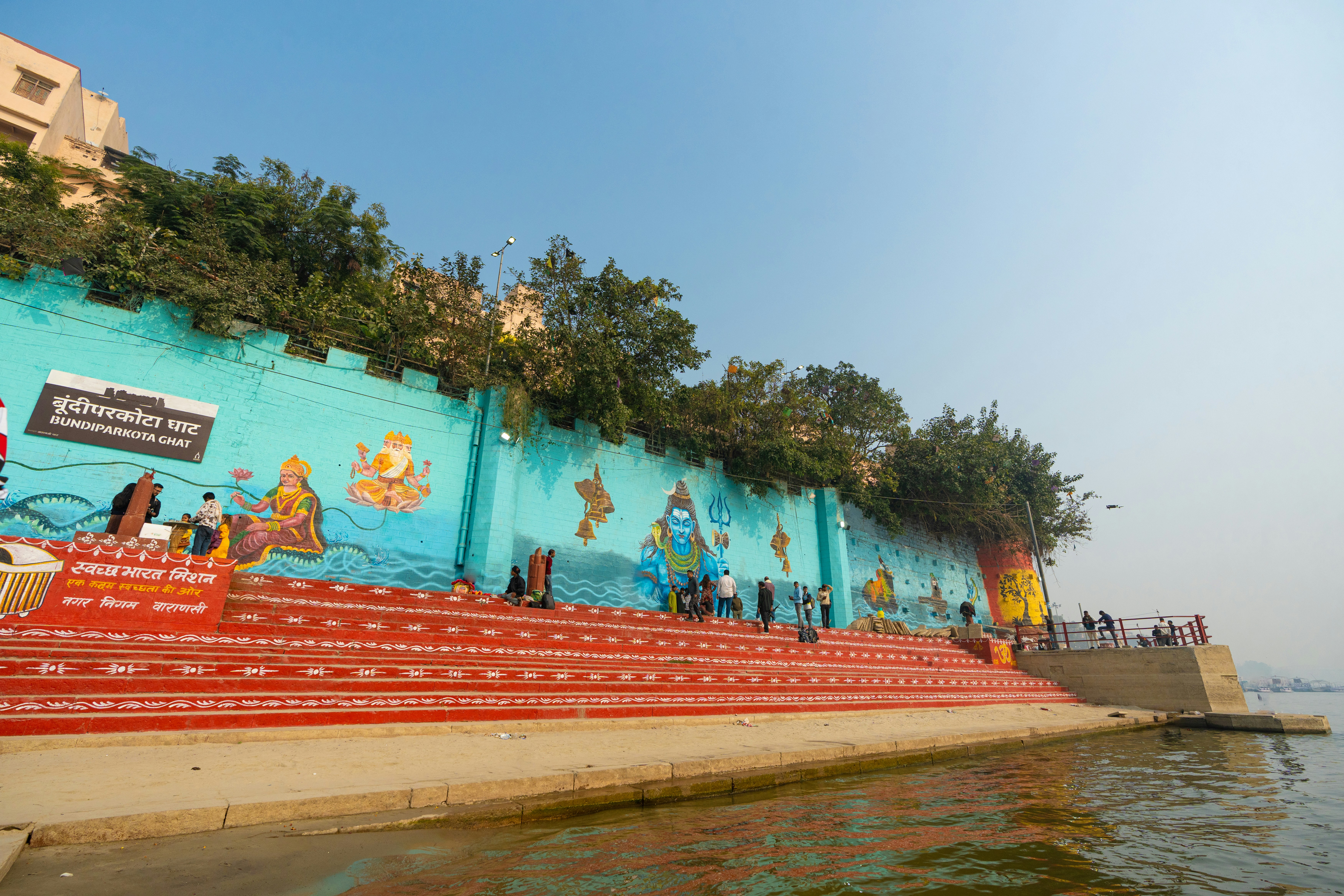 Steps leading to a vibrant mural by the water