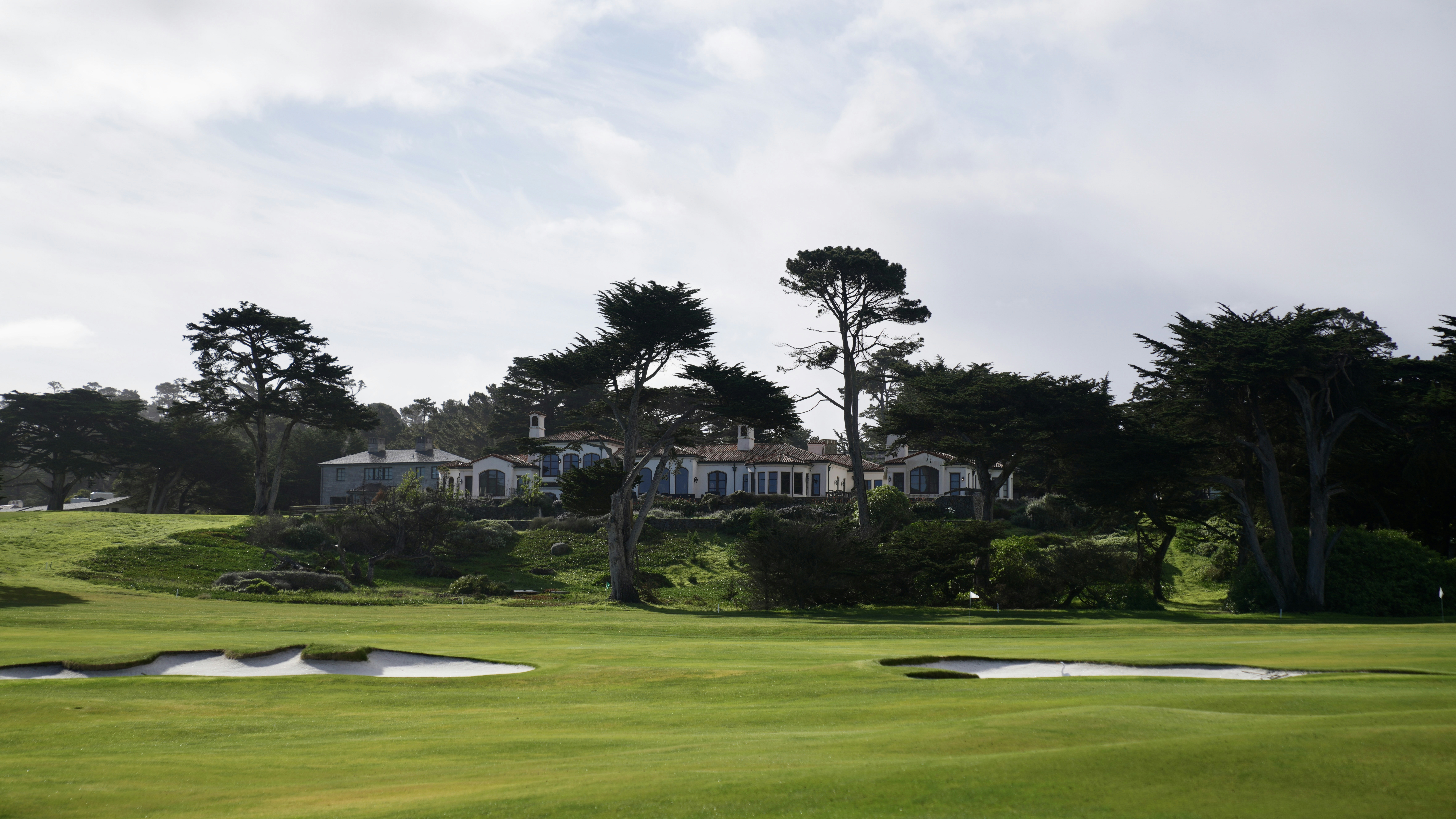 A golf course with a building in the background.